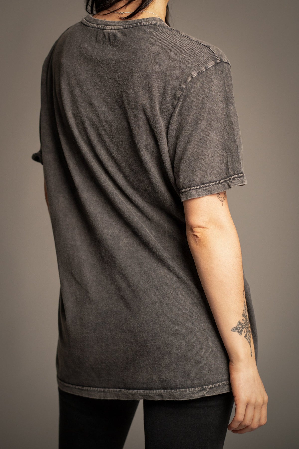 Back view of Victoria wearing the Sex Pistols charcoal vintage wash band T-shirt