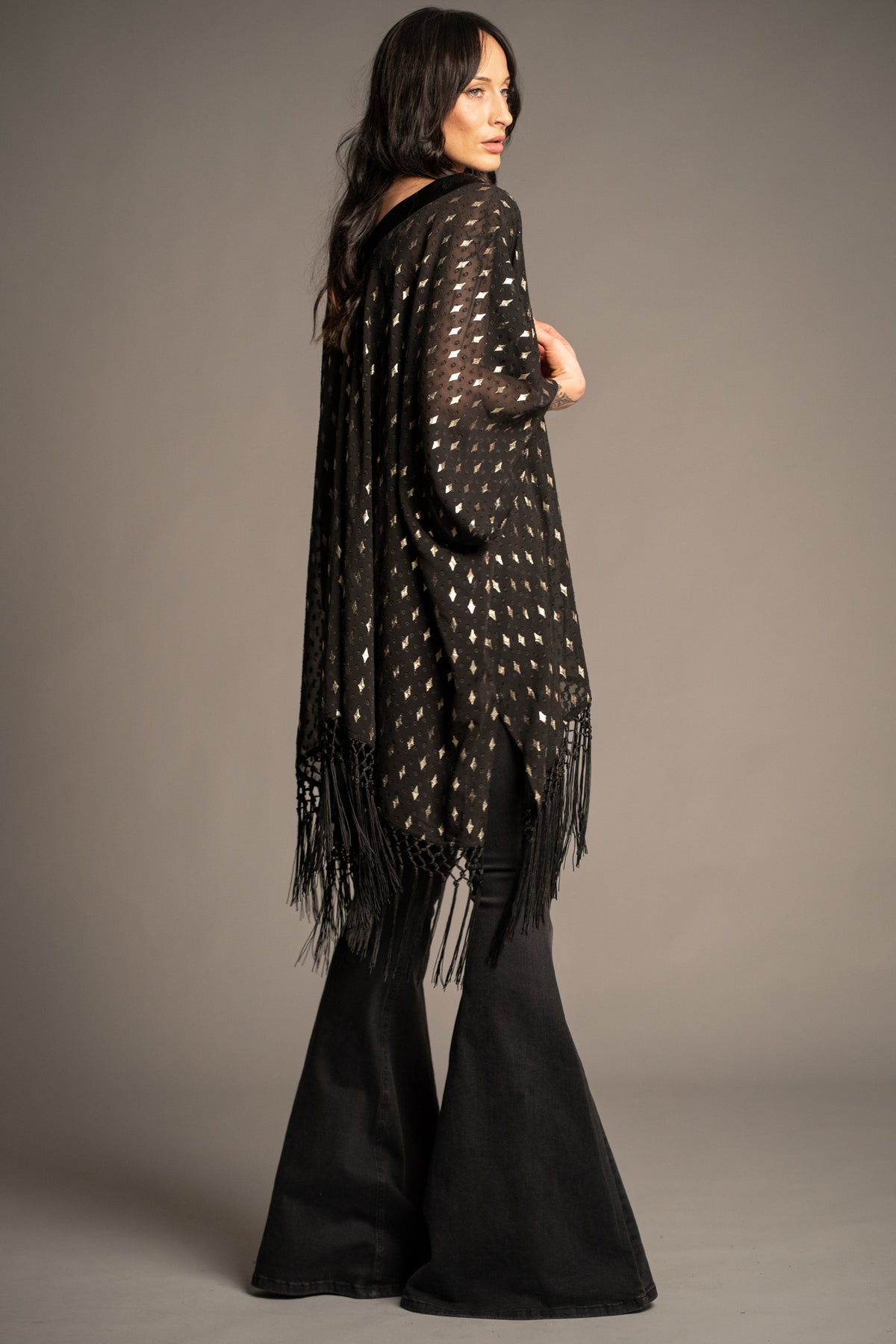 Songbird black metallic kimono back view with gold metallic star print, relaxed draped fit and tassel fringe trim