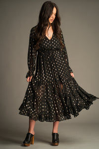 Front view of the Space Oddity Metallic Maxi Dress featuring a sheer black overlay, metallic gold foil print, drawstring waist and tiered maxi silhouette