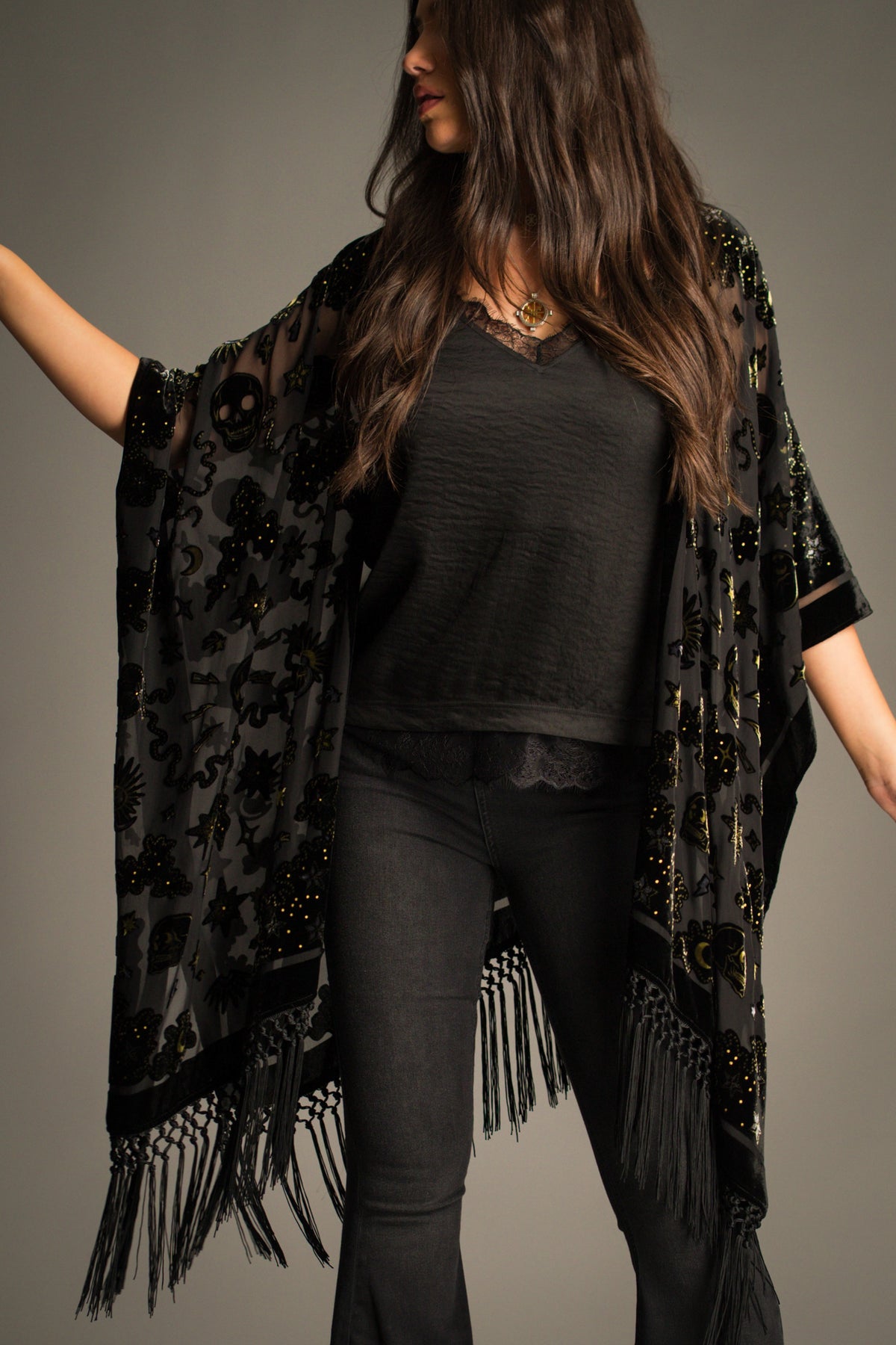 Close-up of the Suzi Skull Black Devore Kimono highlighting the velvet burnout skull pattern, celestial symbols, sheer fabric and tassel fringe detailing