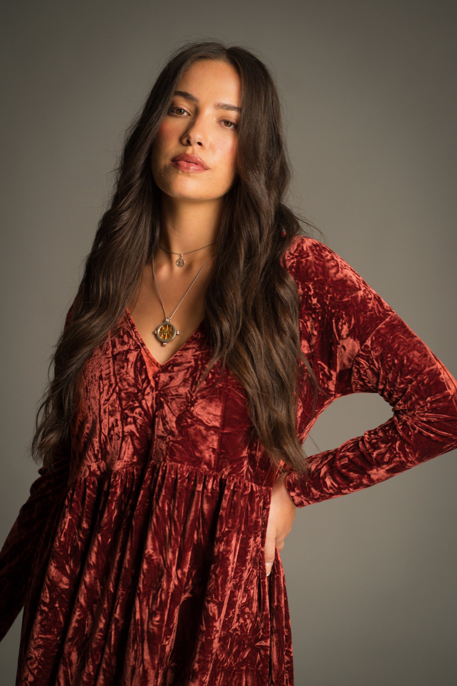 Close top view of the Velvet Goldmine Rust Smock Dress showing V-neckline and lustrous copper-rust crushed velvet.