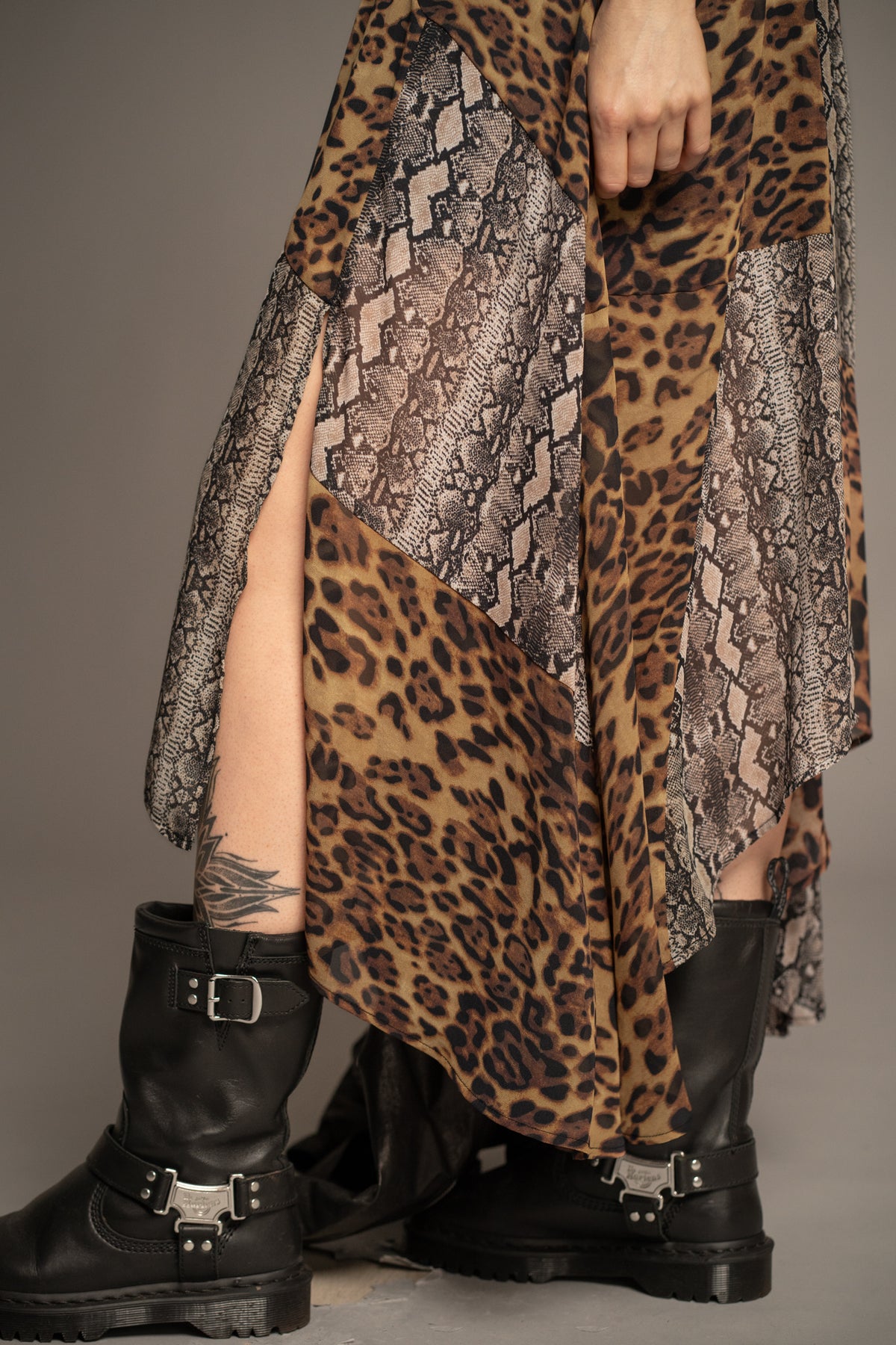 Close-up of Little Lies Zadie Animal Handkerchief Dress highlighting patchwork leopard and snakeskin prints, soft drape fabric and asymmetric hem
