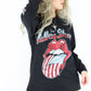 Model wearing The Rolling Stones '78 Long Sleeve Tee - Black Long Sleeve Rolling Stones Tee with American Flag Print Tongue Design on front and Tour Dates on back