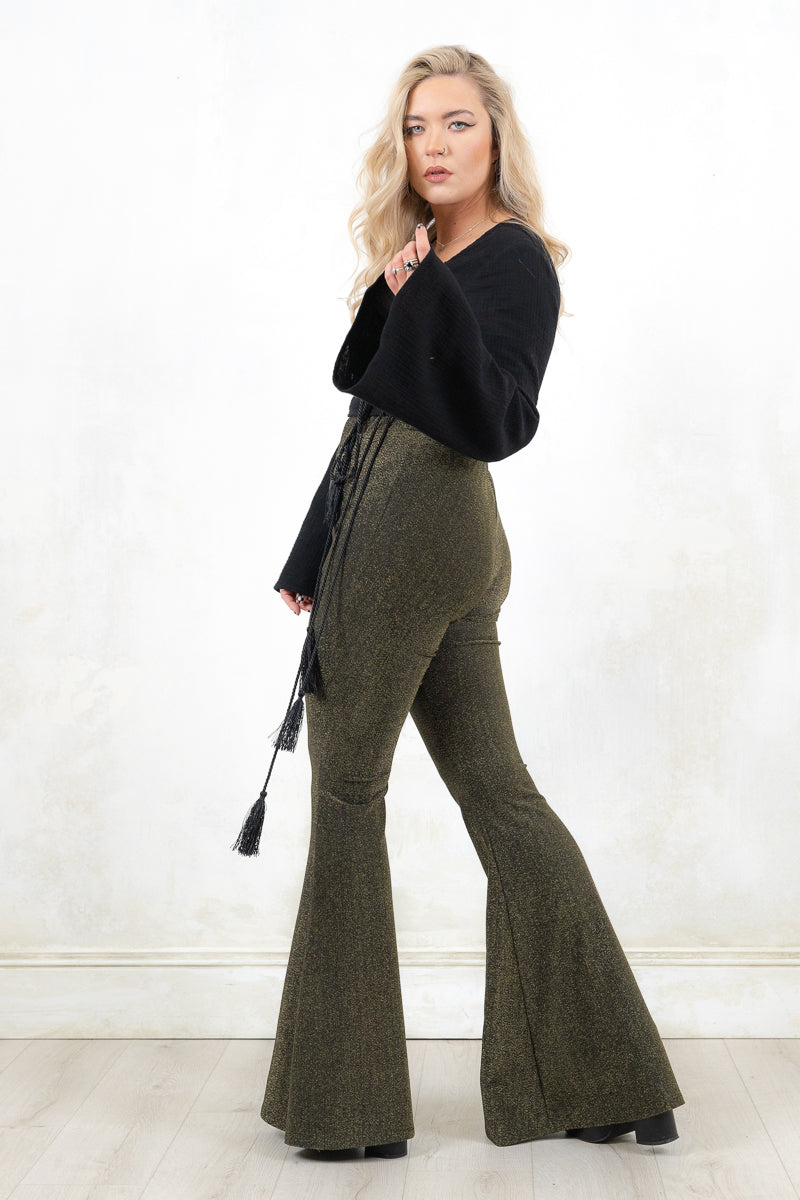 Model wearing Hendrix Metallic Flares - black/gold metallic flares with major retro bell bottom