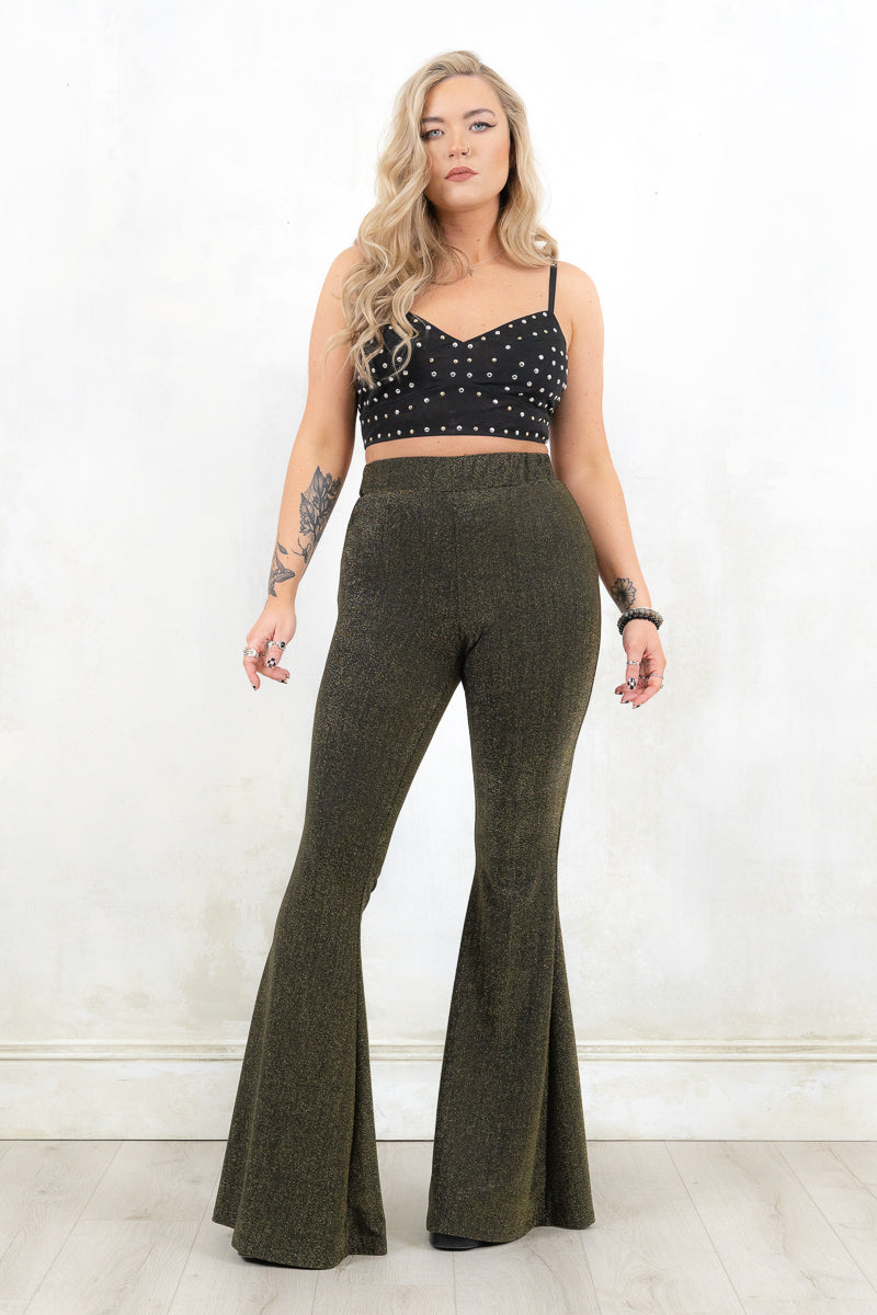 Model wearing Hendrix Metallic Flares - black/gold metallic flares with major retro bell bottom