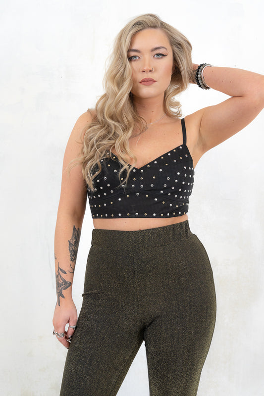 Model wearing Metal Guru Studded Bralette- Black cropped bralette with gold/silver mixed metal studs and adjustable straps and   