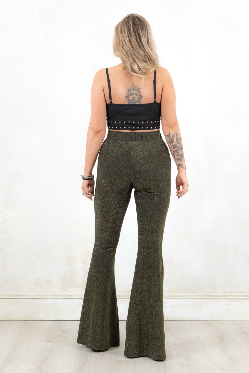 Model wearing Hendrix Metallic Flares - black/gold metallic flares with major retro bell bottom