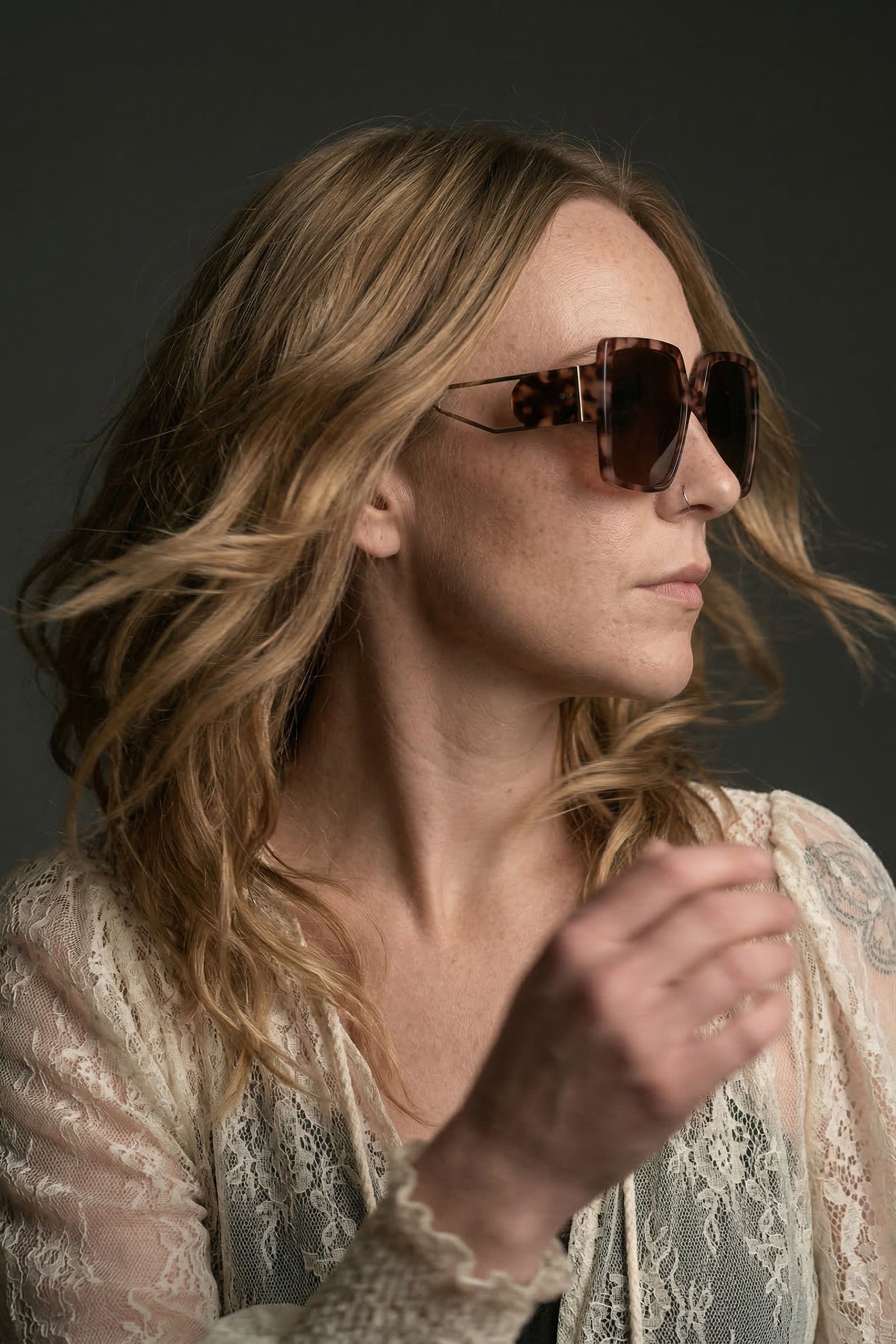 Model wearing oversized square sunglasses styled with boho outfit
