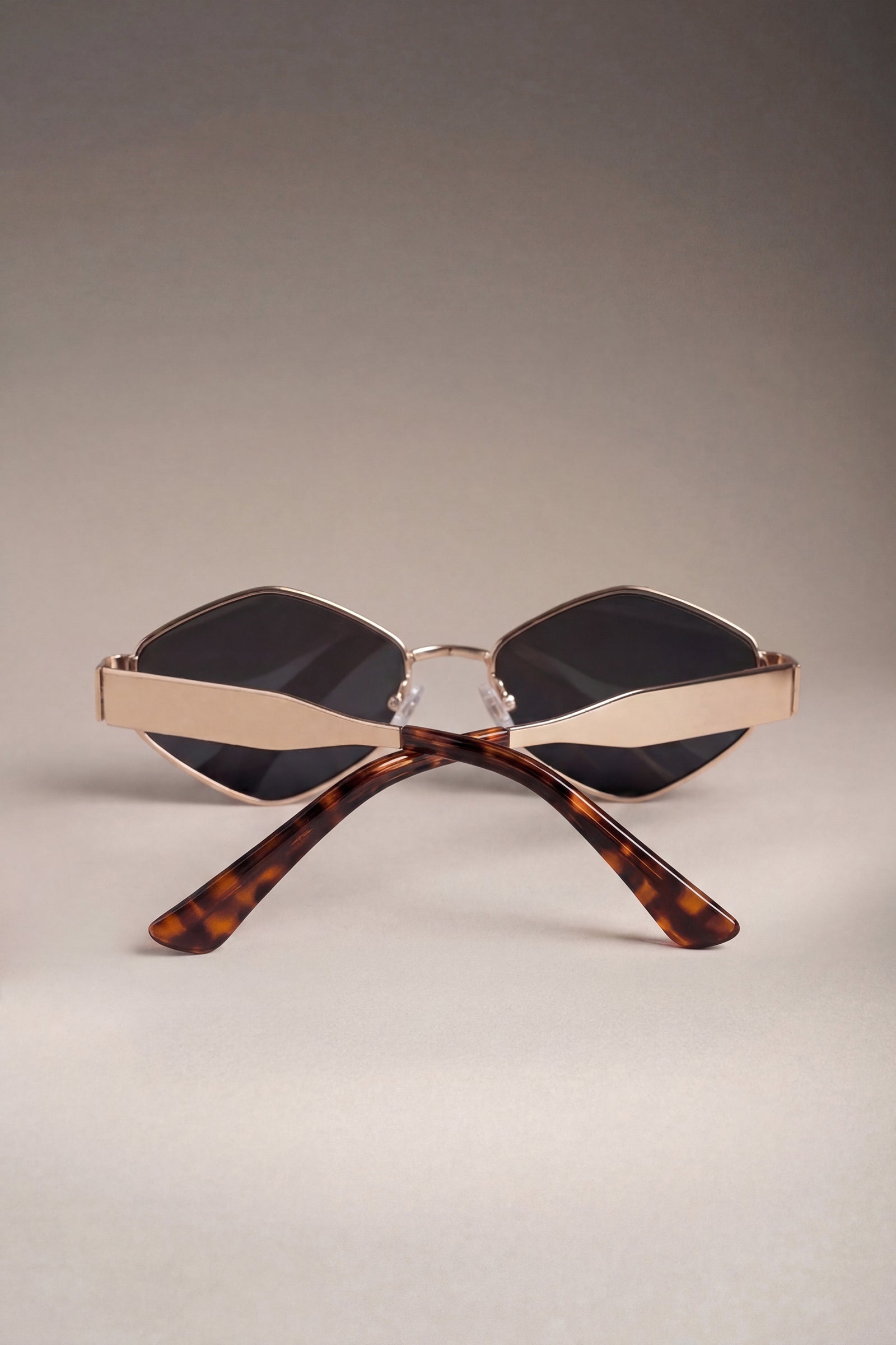 Detail of gold metal frame sunglasses