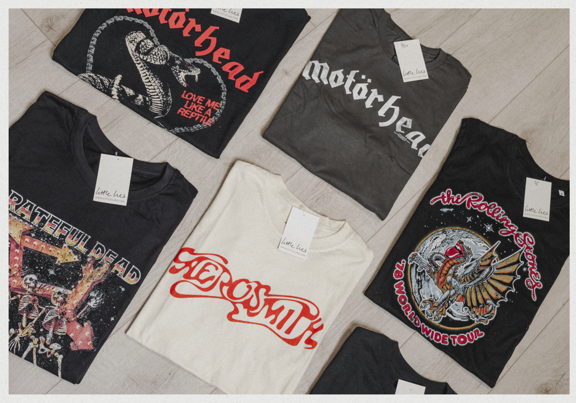 Motorhead, The Rolling Stones, Aerosmith & The Grateful Dead Band Tee's folded on white wooden floor