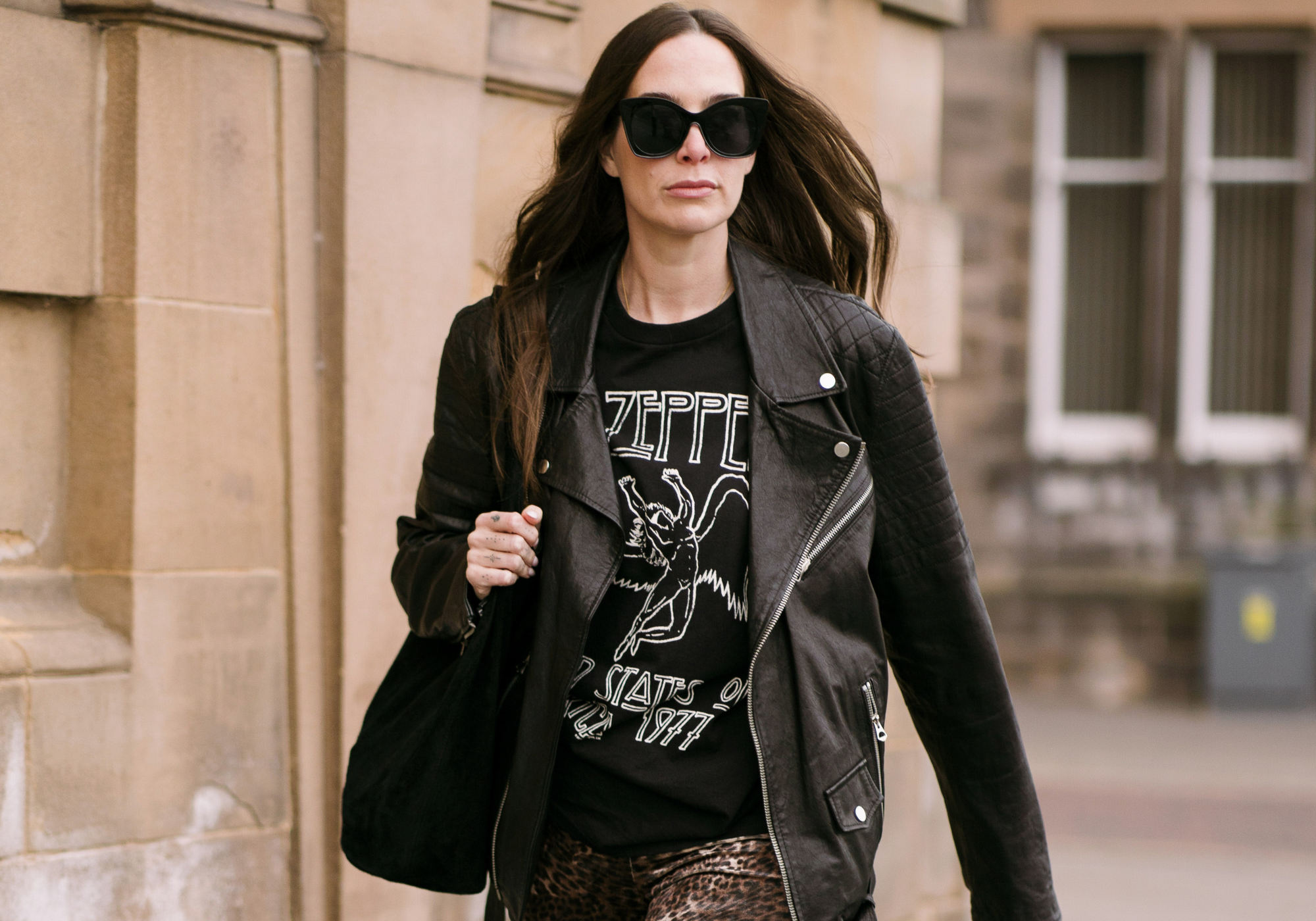 Bex on street wearing the Led Zeppelin 1977 band tee, leather Jacket and Hendrix Leopard velvet flares.