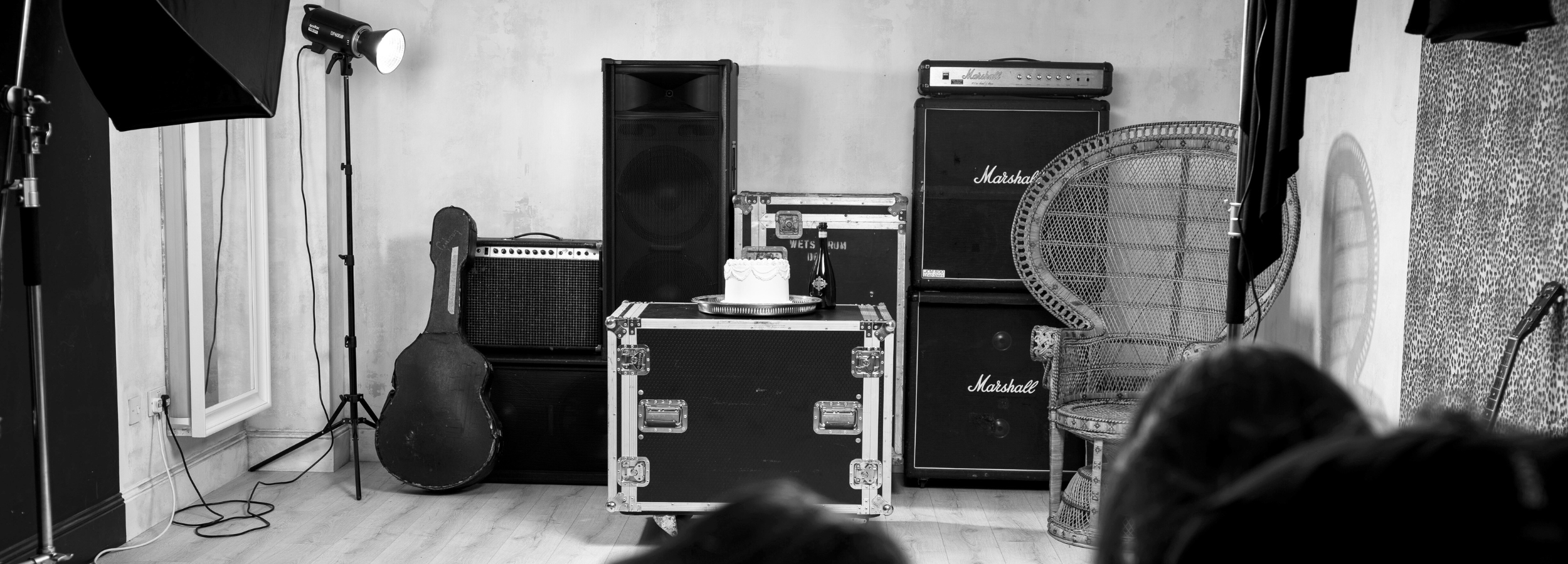 On set with Little Lies, Marshall amp stack, Peacock chair, Guitar, Flight cases, rock 'n roll & bohemian Style. 