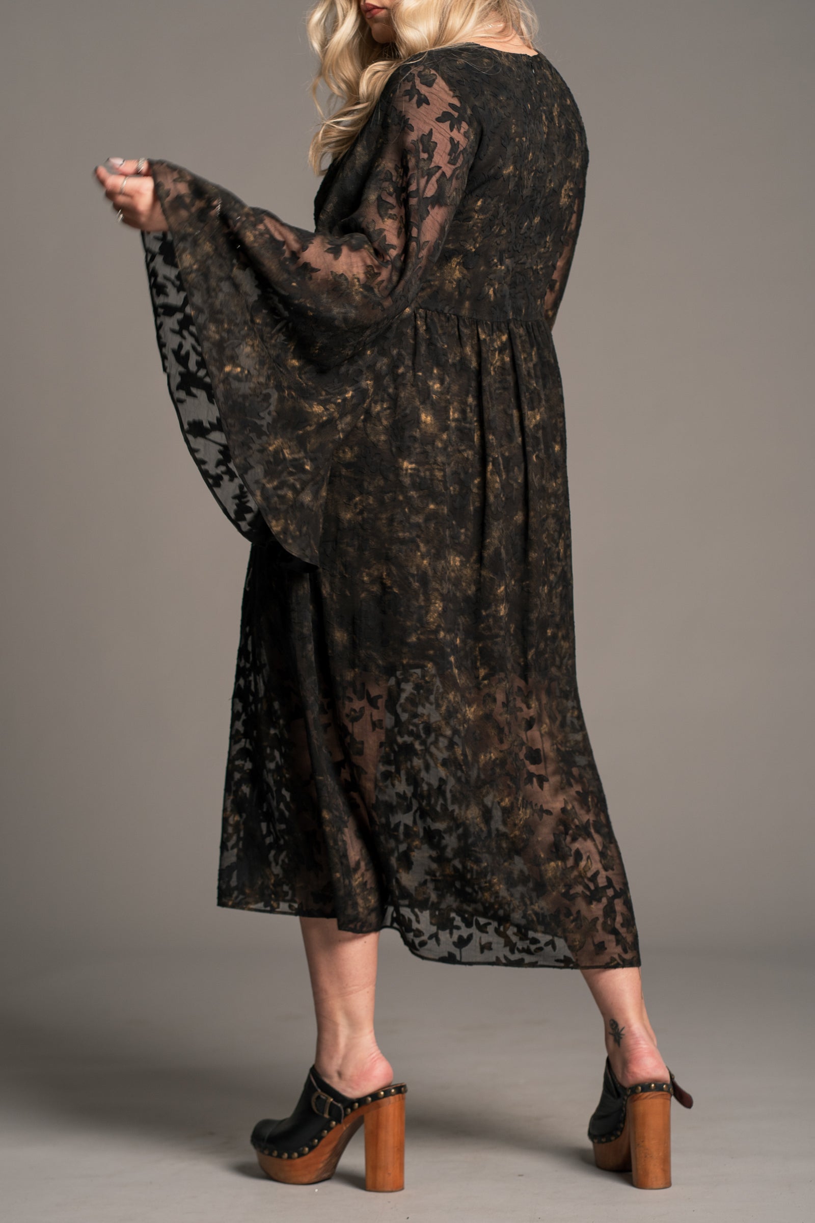Little Lies Bella Donna black lace midi dress with sheer floral overlay and wide sleeves, on‑model back view
