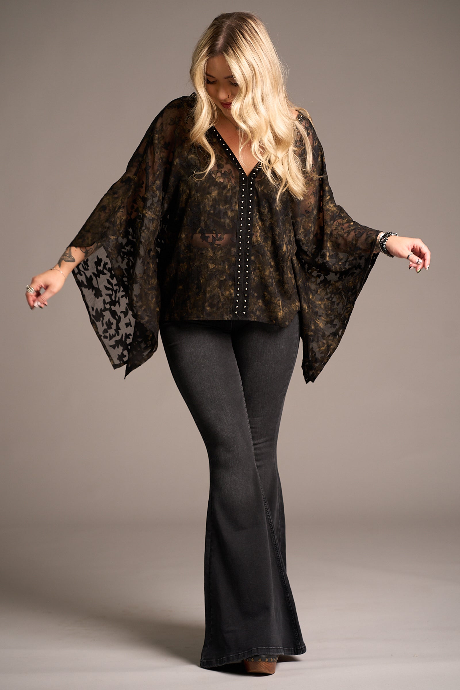 Erin in Bella Donna Studded Kimono Top
with flared jeans, against a neutral backdrop, Stevie Nicks inspired styling studio