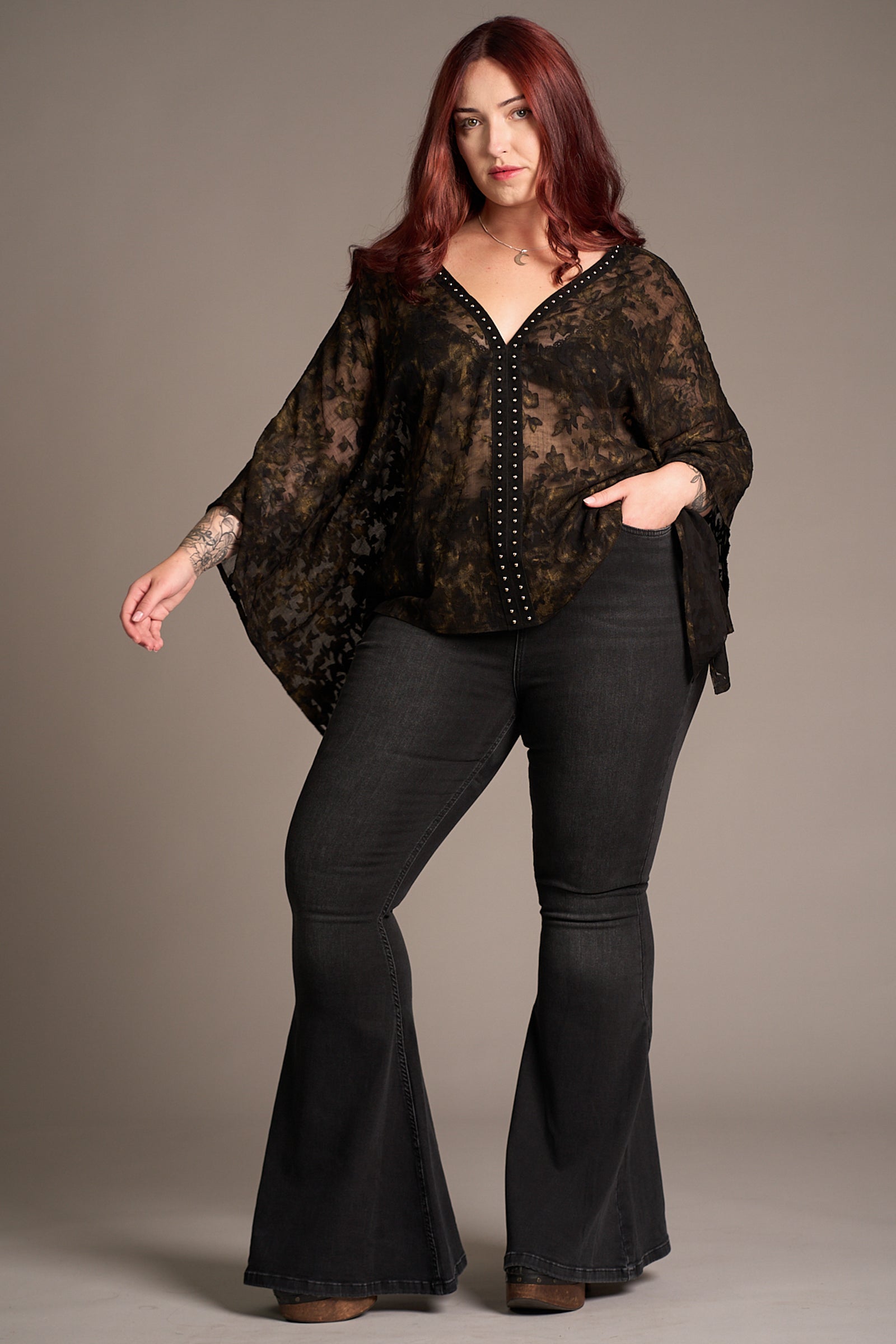 Taylor in the Bella Donna Studded Kimono Top with sheer black fabric, wide sleeves, and stud embellishment, styled with flared jeans, Stevie Nicks inspired styling studio