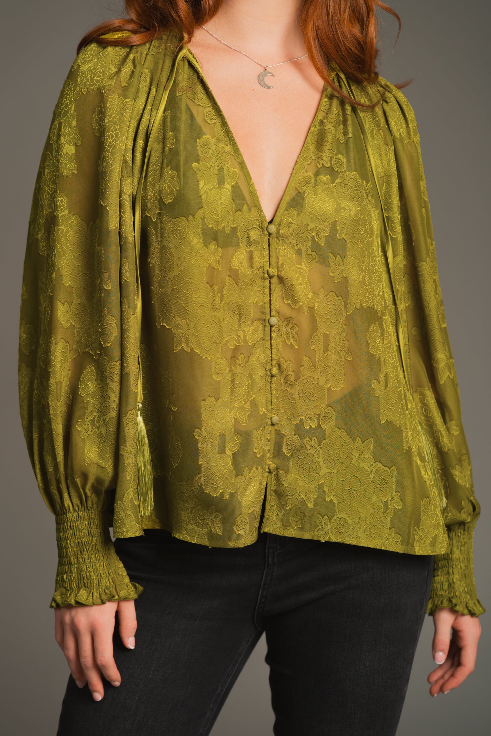Close-up of Cassia Olive smock top showing neckline with drawstring tie and subtle pattern