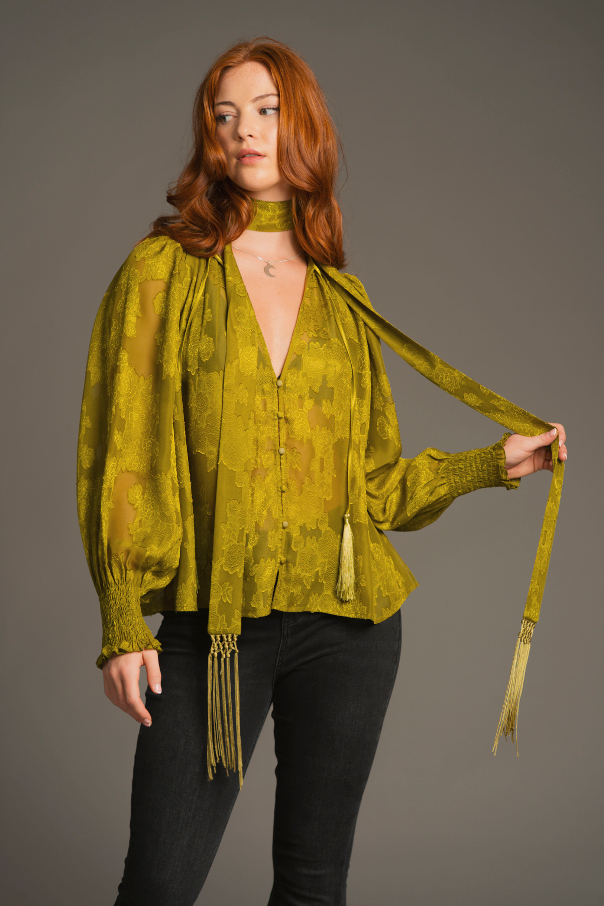 Lifestyle pose emphasizing relaxed fit and boho-inspired styling of the Cassia Olive Smock Top with Olive Skinny fringed scarf.