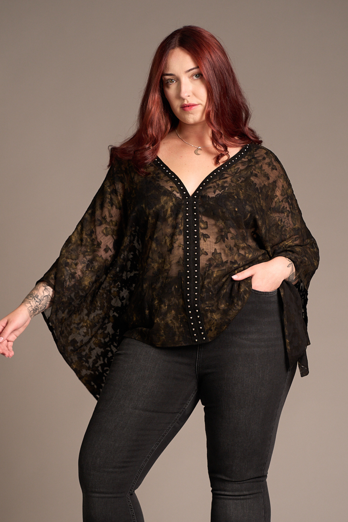 Taylor wearing the Little Lies Bella Donna Studded Kimono Top in sheer dark floral chiffon paired with Hendrix Denim Flares, studio setting