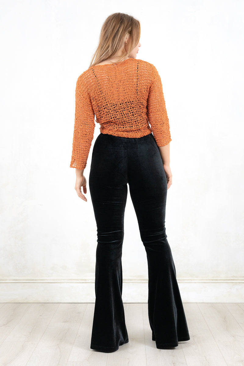 Model wearing Graceland Rust Shrug- Rust fine knit shrug with tie front