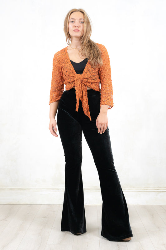 Model wearing Graceland Rust Shrug- Rust fine knit shrug with tie front