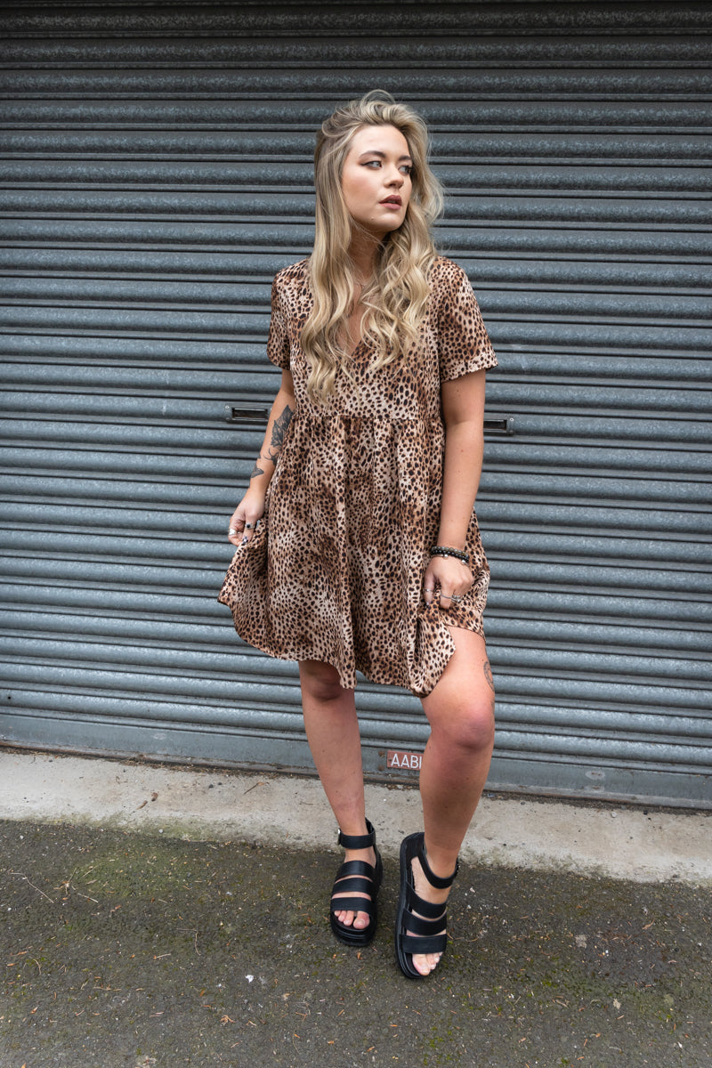 Model wearing Come as You Are Leopard Dress, leopard print, v-neck smock dress with no button or zip fastenings