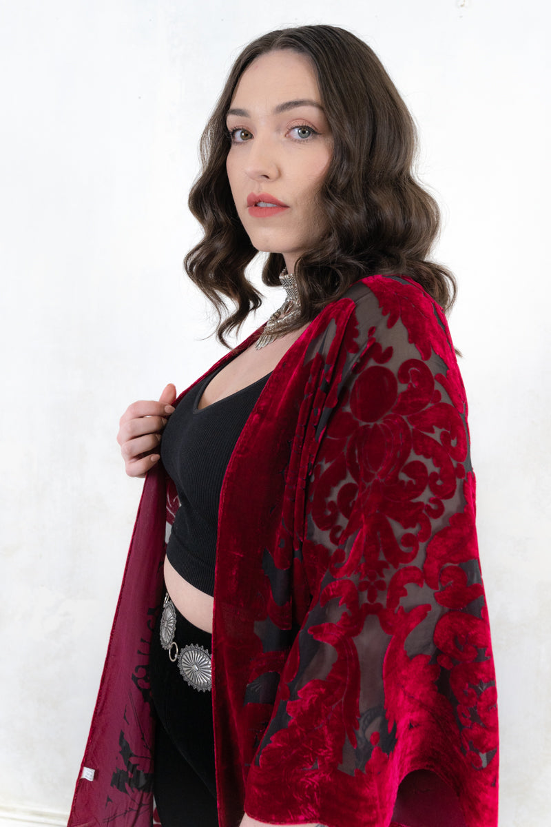 Model wearing Mystic Queen Raspberry Devore Kimono - raspberry devore burnout velvet kimono with a relaxed shape adorned with fringing