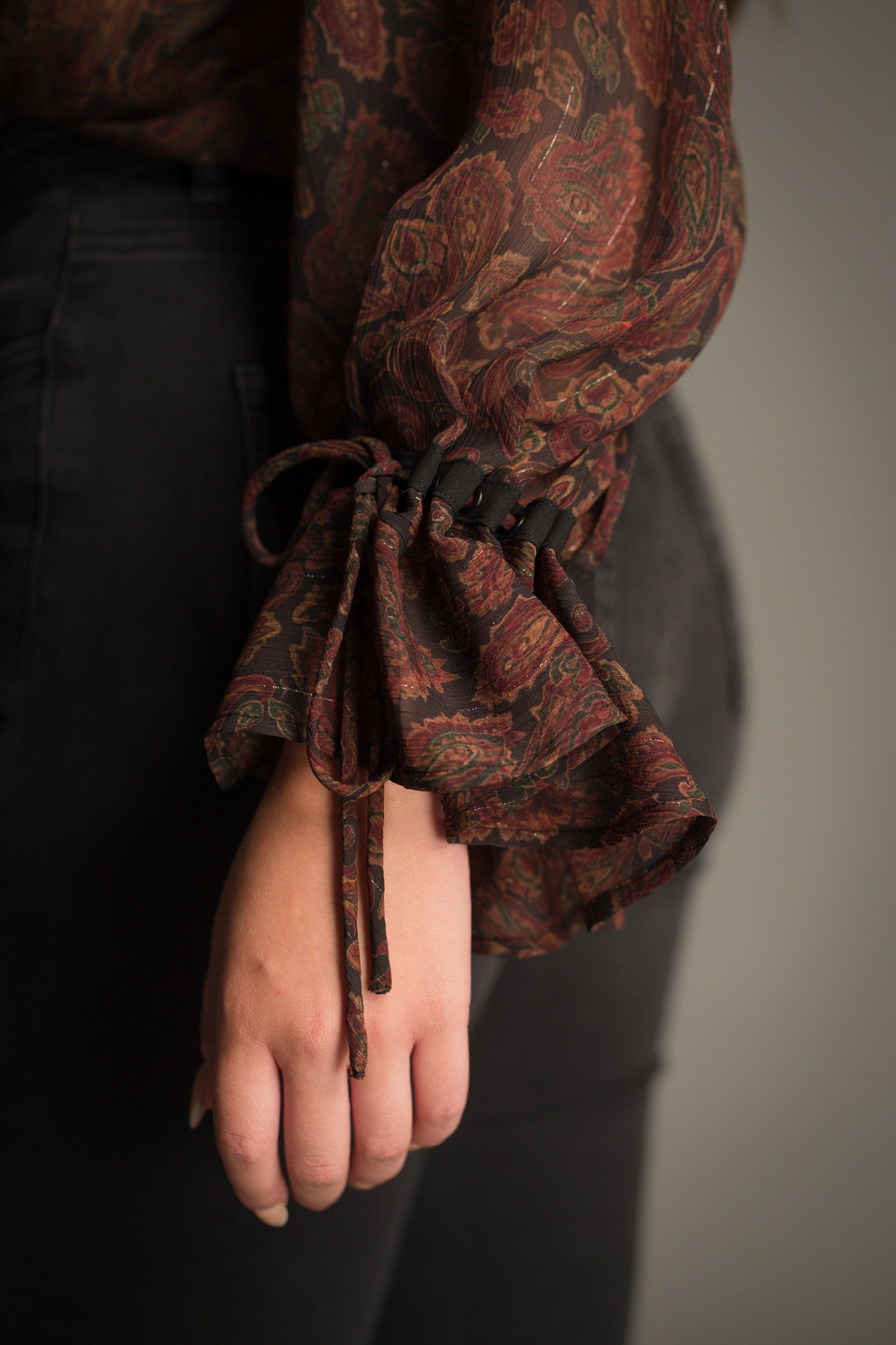 Sleeve tie detail on the Dark Paradise Paisley Boho Top styled with Hendrix Flares and boots.