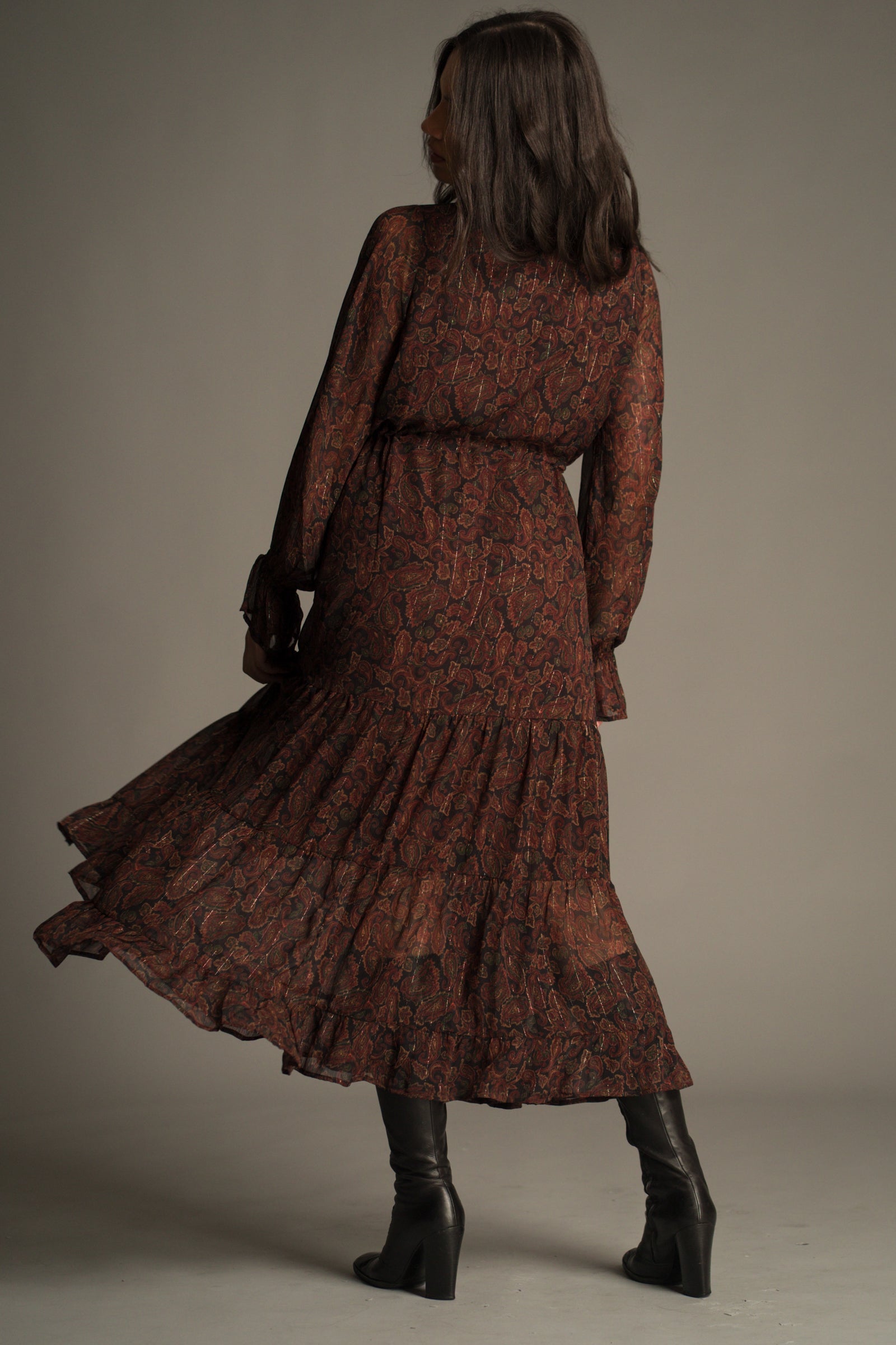 Back view of the Dark Paradise Paisley Maxi Dress showing adjustable drawstring waist and fluid silhouette.