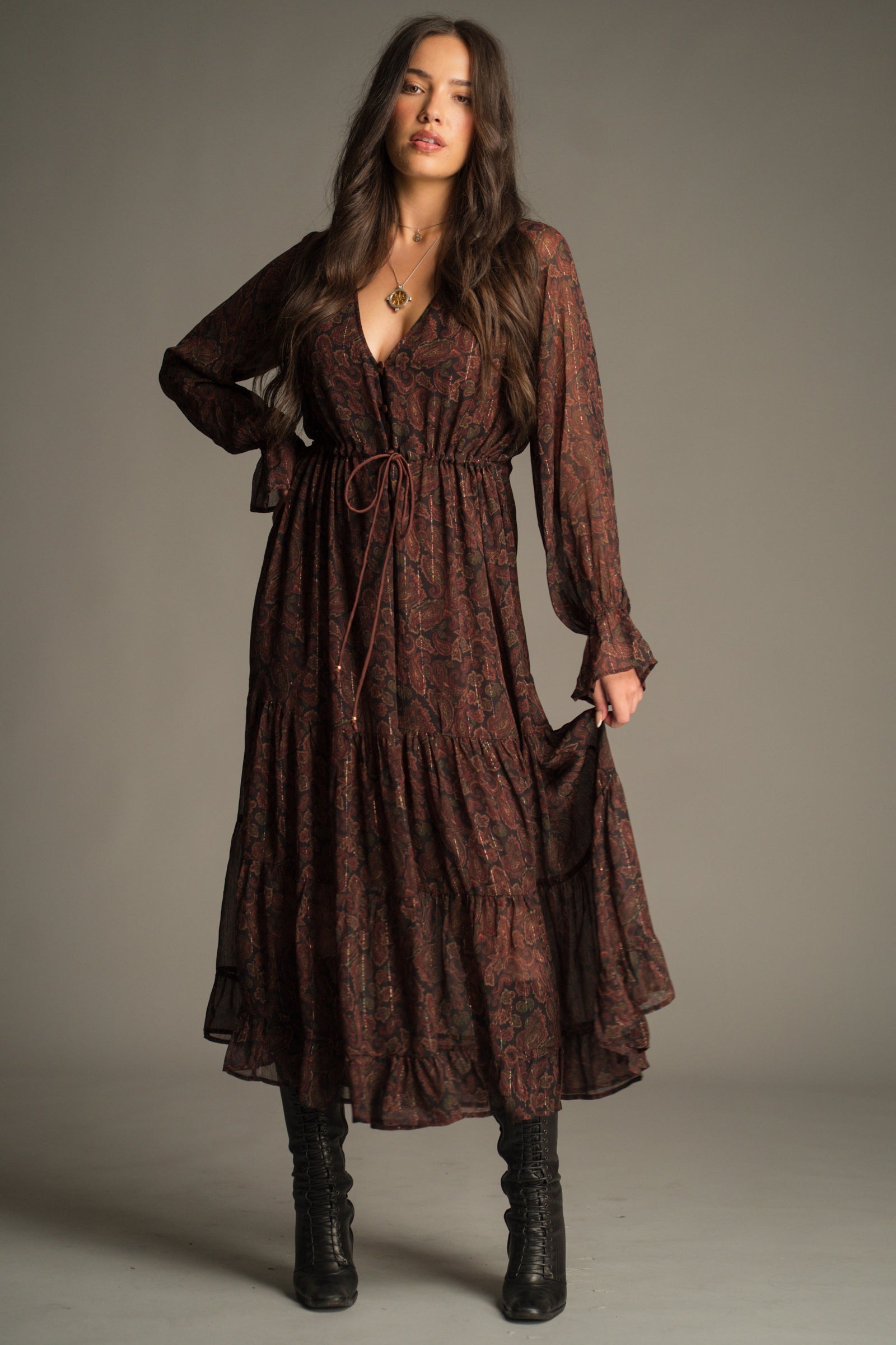 Front view of the Dark Paradise Paisley Maxi Dress showing sheer sleeves, beaded waist tie and flowing maxi length.