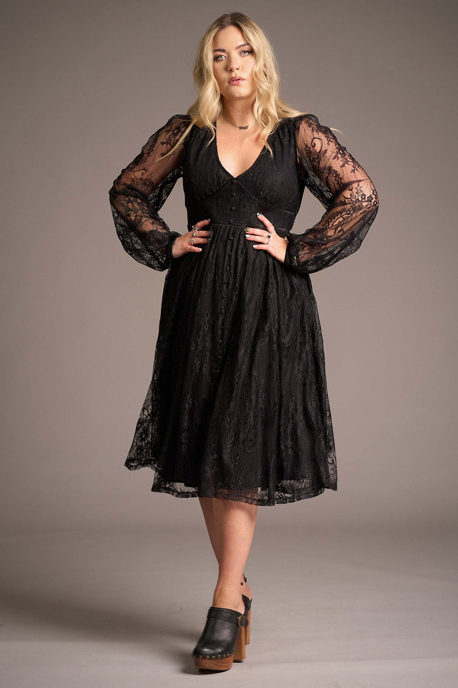 Erin wears the Dazed Black Lace Midi Dress with sheer sleeves and V-neckline, highlighting elegant lace detail and flattering A-line fit. Stevie Nicks inspired styling studio