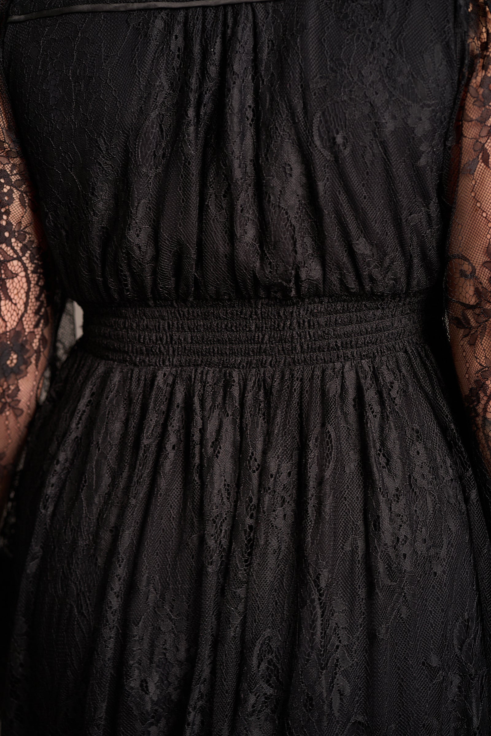 Close-up of the back of Dazed Black Lace Midi Dress with sheer sleeves and intricate lace detail, elasticated waist highlighted. Stevie Nicks inspired styling studio
