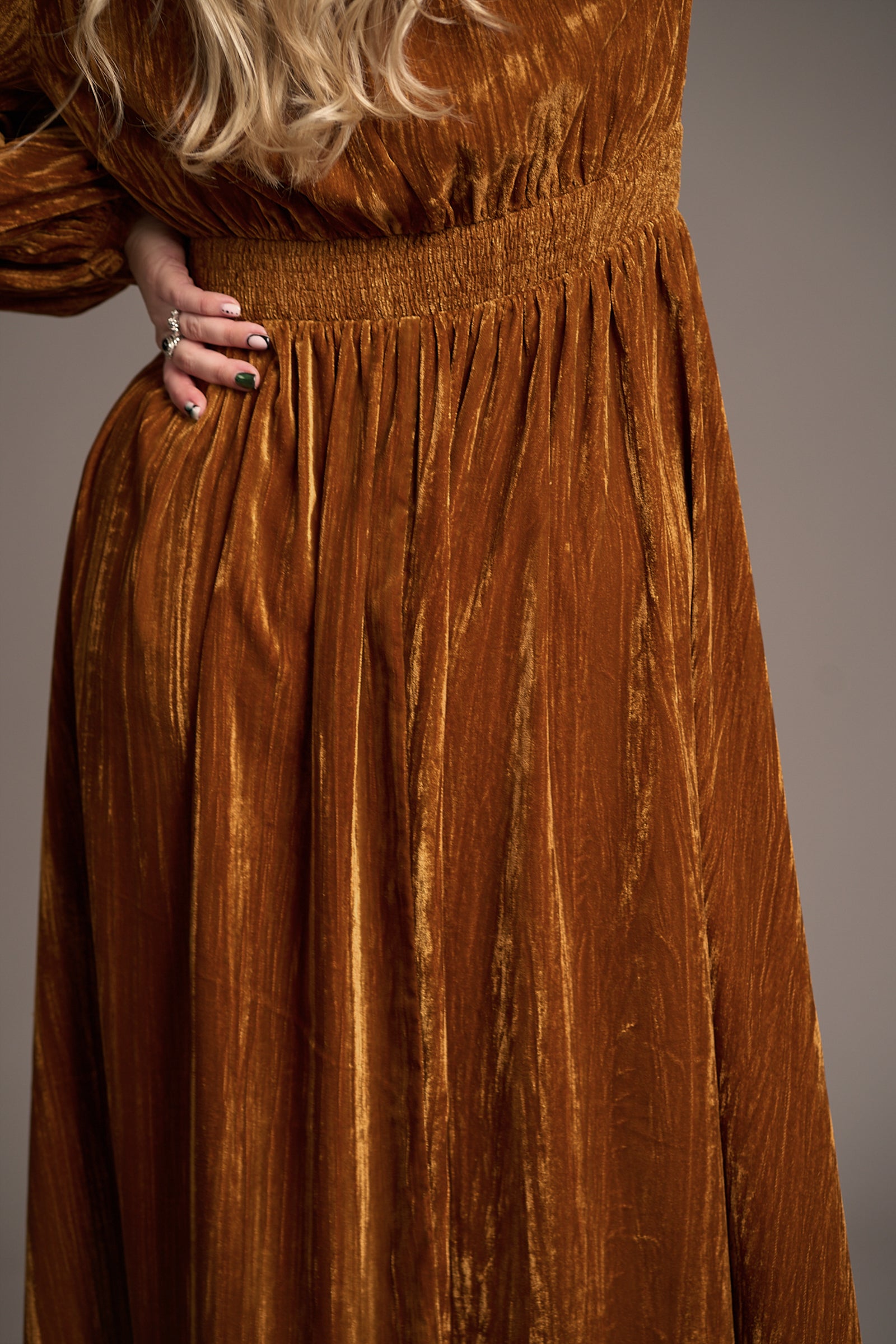 Close-up of Erin wearing Dazed Copper Velvet Midi Dress with gathered waist and rich textured fabric, Stevie Nicks inspired styling studio