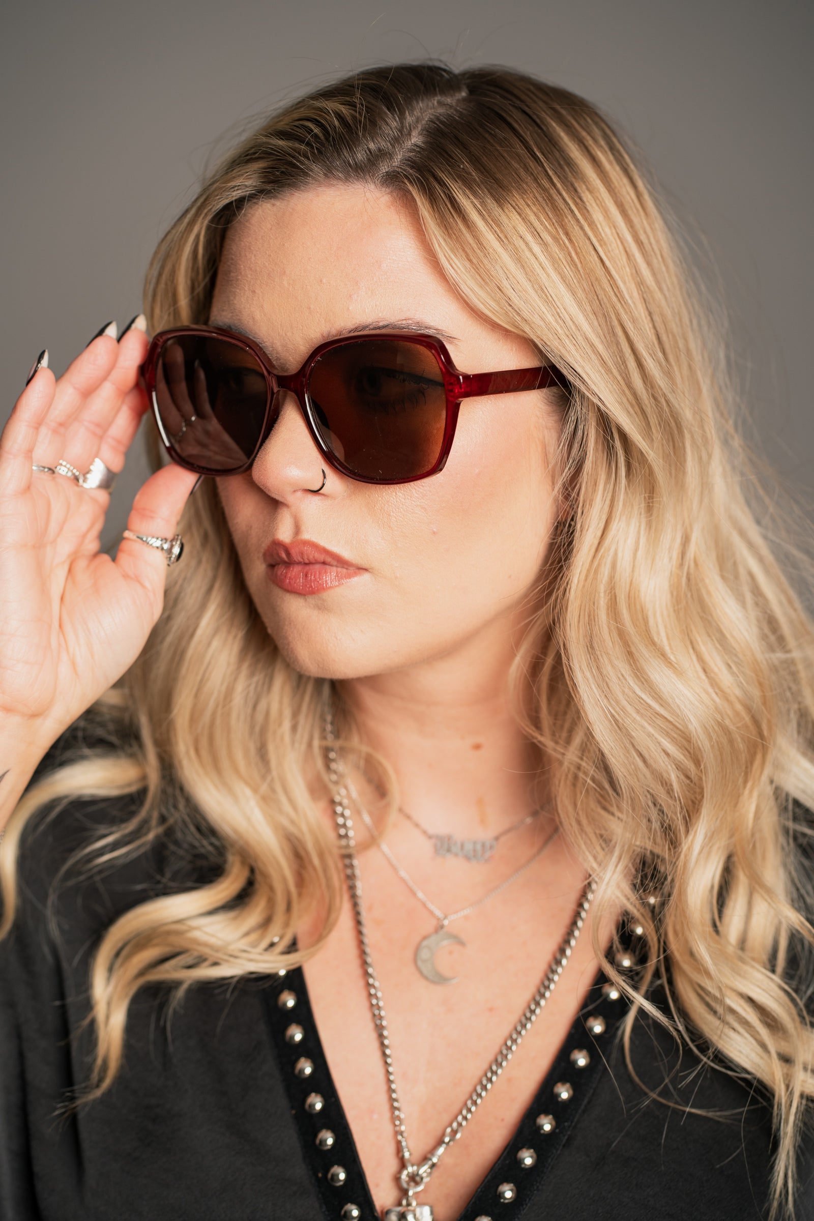 Little Lies crimson red sunglasses with retro oversized square frame and dark tinted lenses