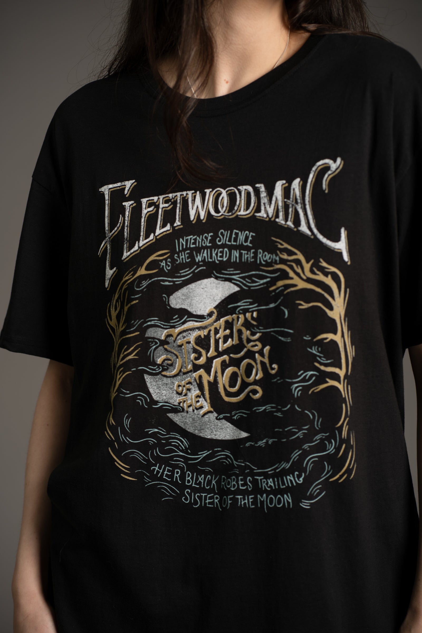 Close-up of Fleetwood Mac Sister of the Moon tee graphic featuring lyrics, a crescent moon, tree branches and wavy cloud like design from Little Lies collection