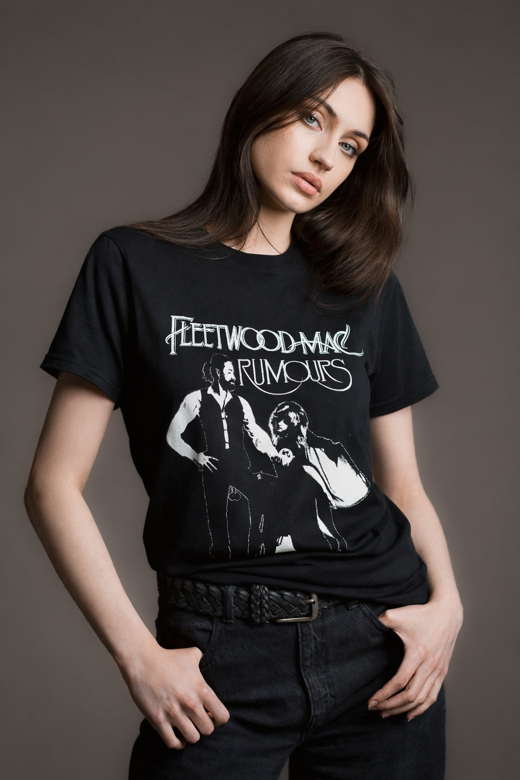 Andie wears black Fleetwood Mac Rumours Black band tee styled with black high‑waisted jeans and a braided belt