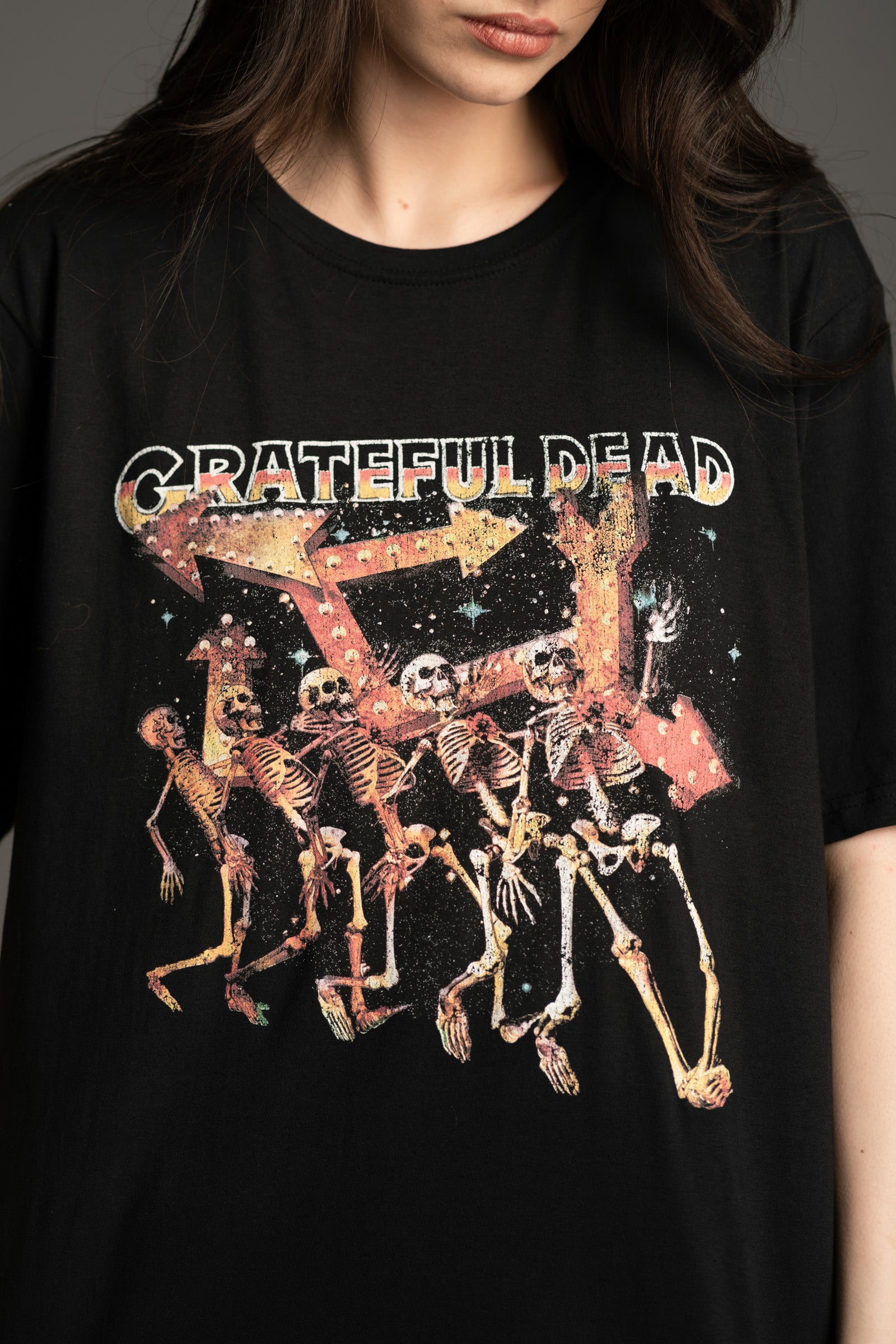 Close-up of dancing skeleton graphic on Grateful Dead band tee from Little Lies
