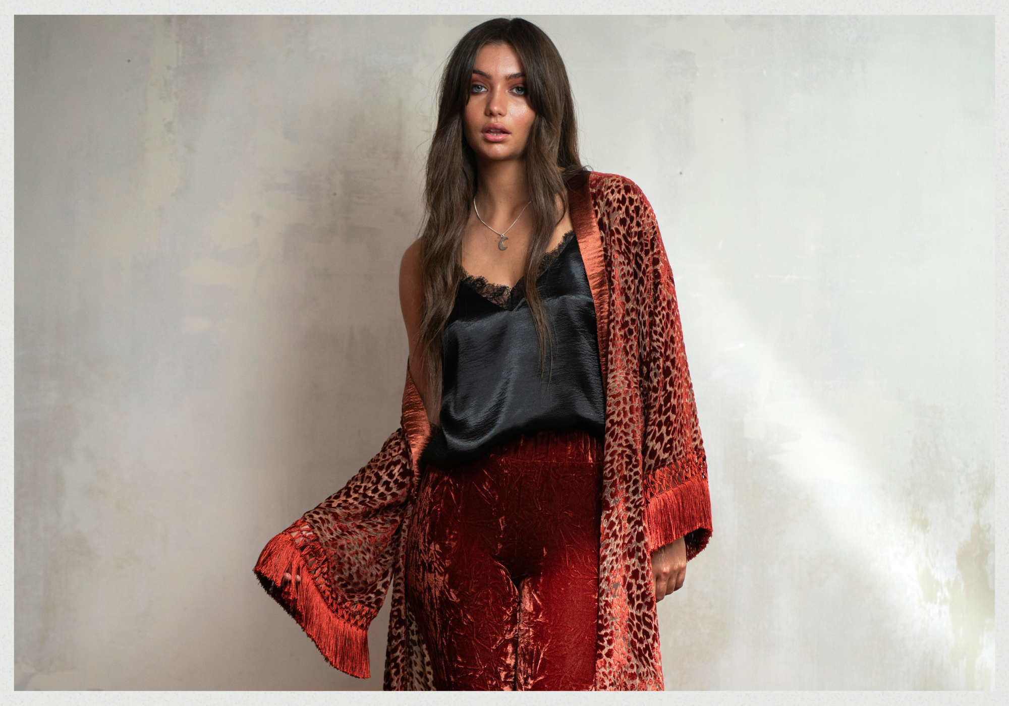 Andie wearing Heartbreaker Rust Devore Fringed Kimono with Sterling silver Crescent Moon necklace, and Hendrix Rust Devore Flares