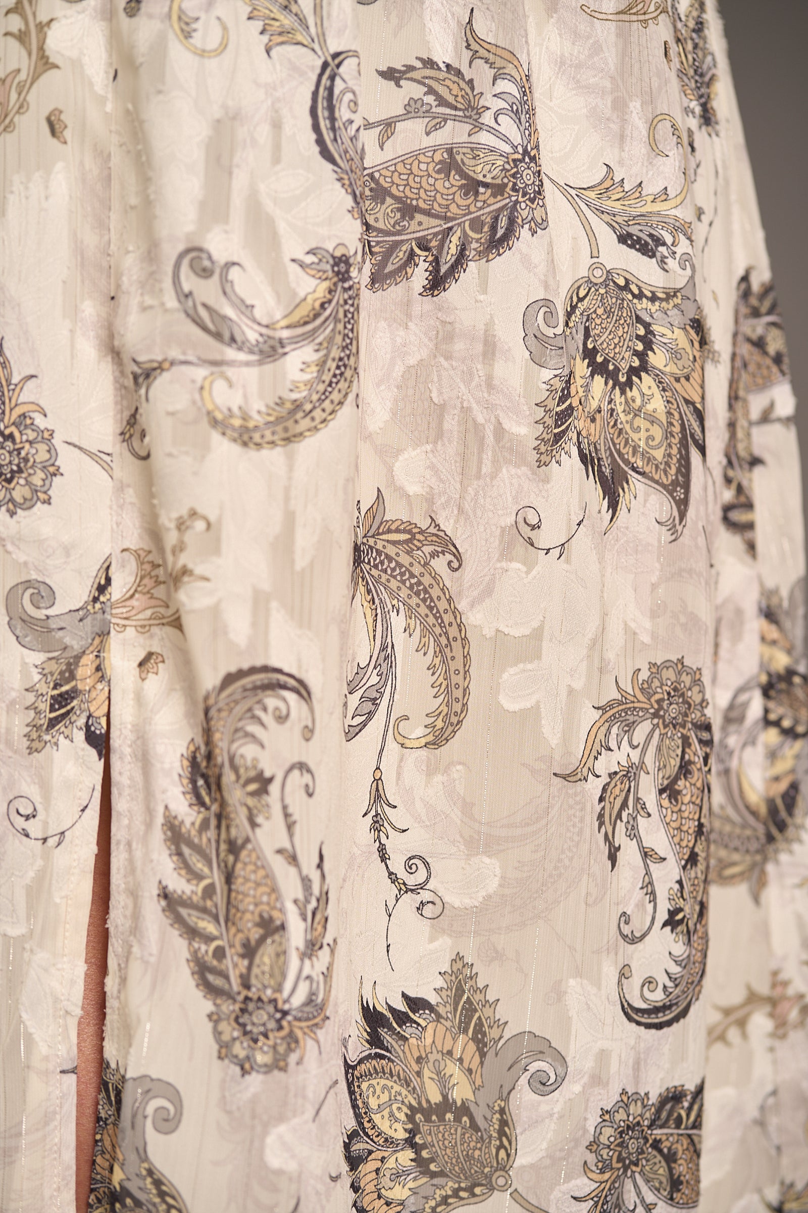 Close up showcasing the Harvest Moon Paisley Midi Dress detailed neutral floral paisley print