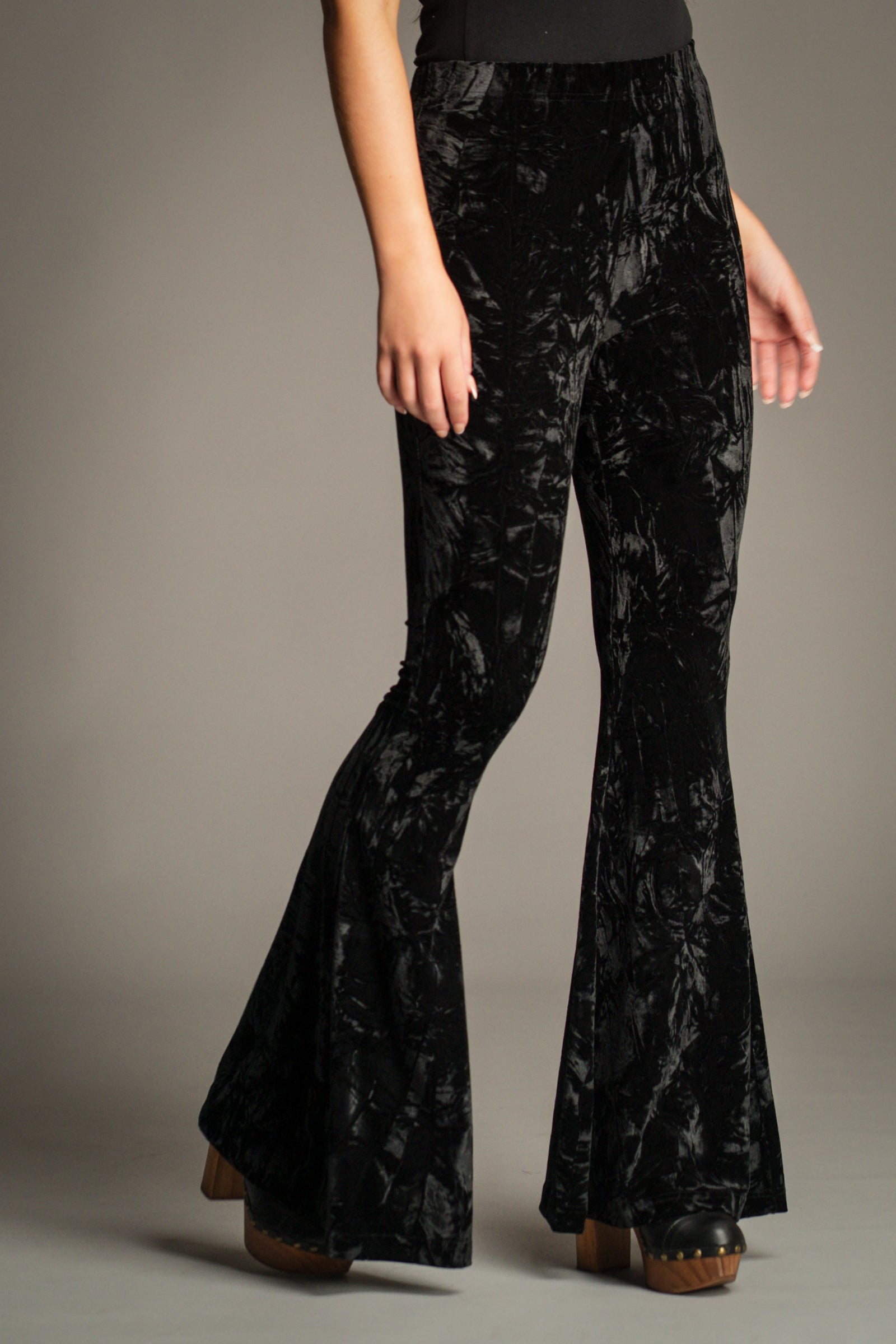 Close-up front view of the Hendrix Black Crushed Velvet Flares showing high-rise fit and velvet texture.
