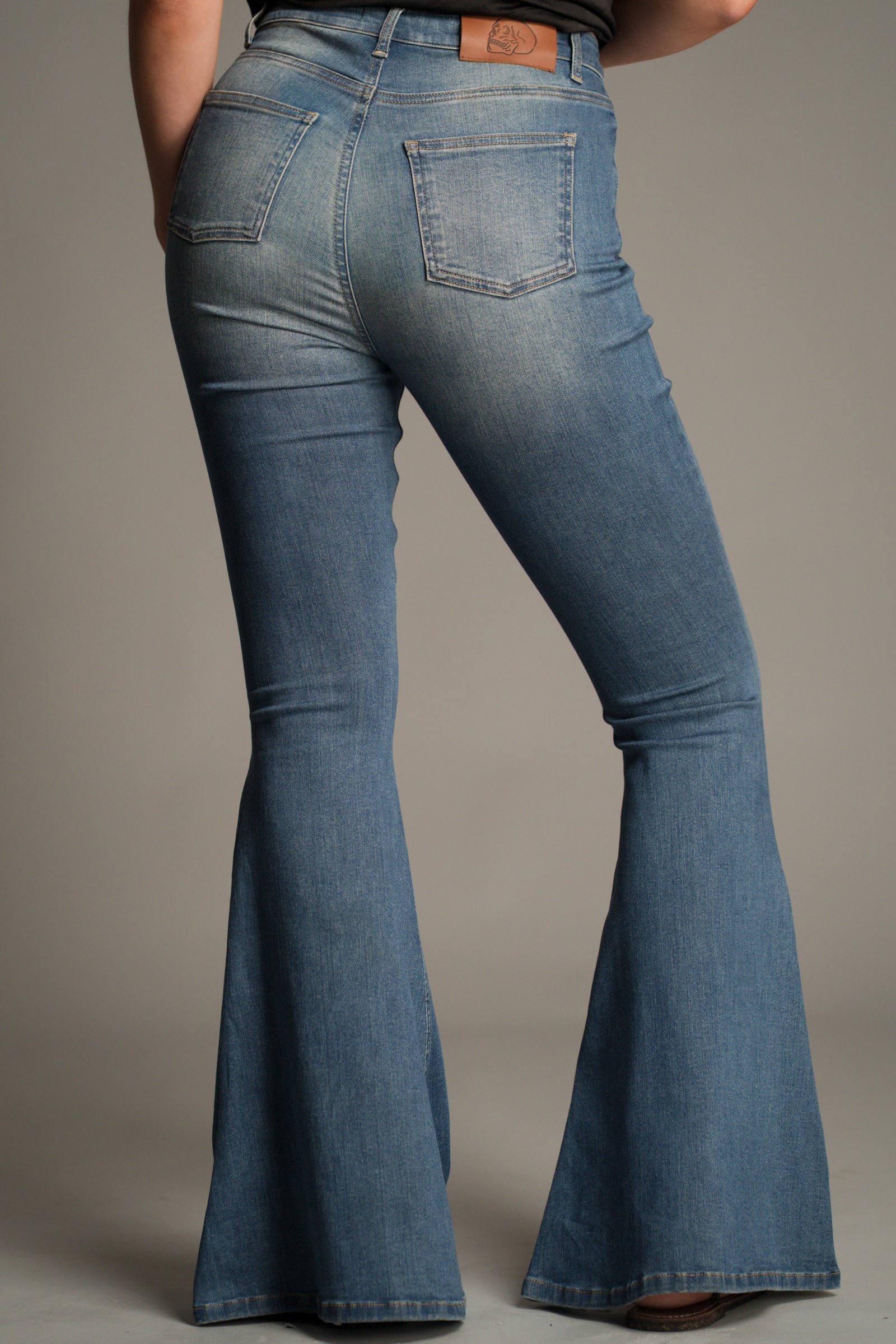 Back view of the Hendrix Blue Denim Flares showing rear patch pockets and flared leg.