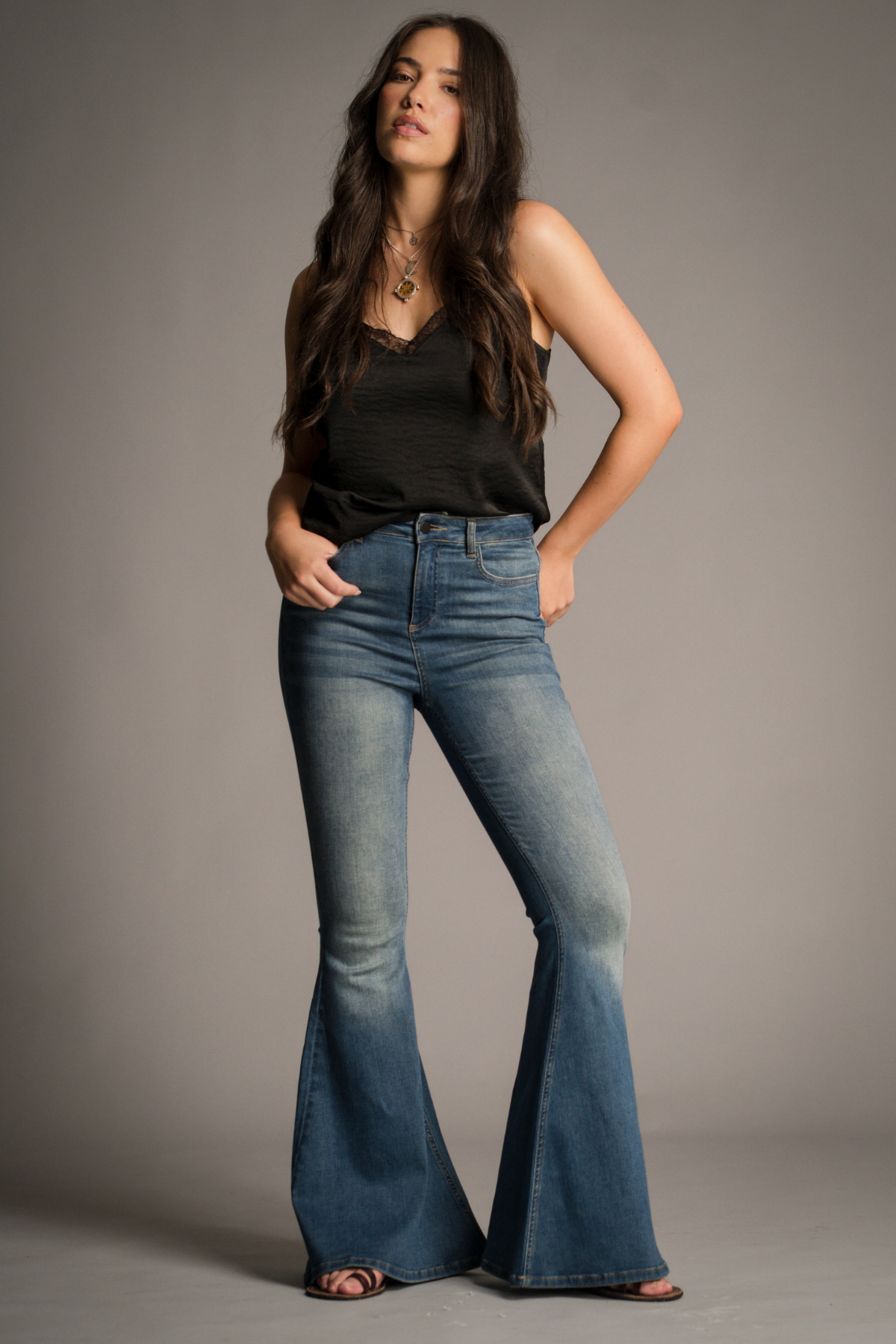 Little Lies blue wash flare jeans featuring a high-rise fit, slim leg and full-length flared silhouette