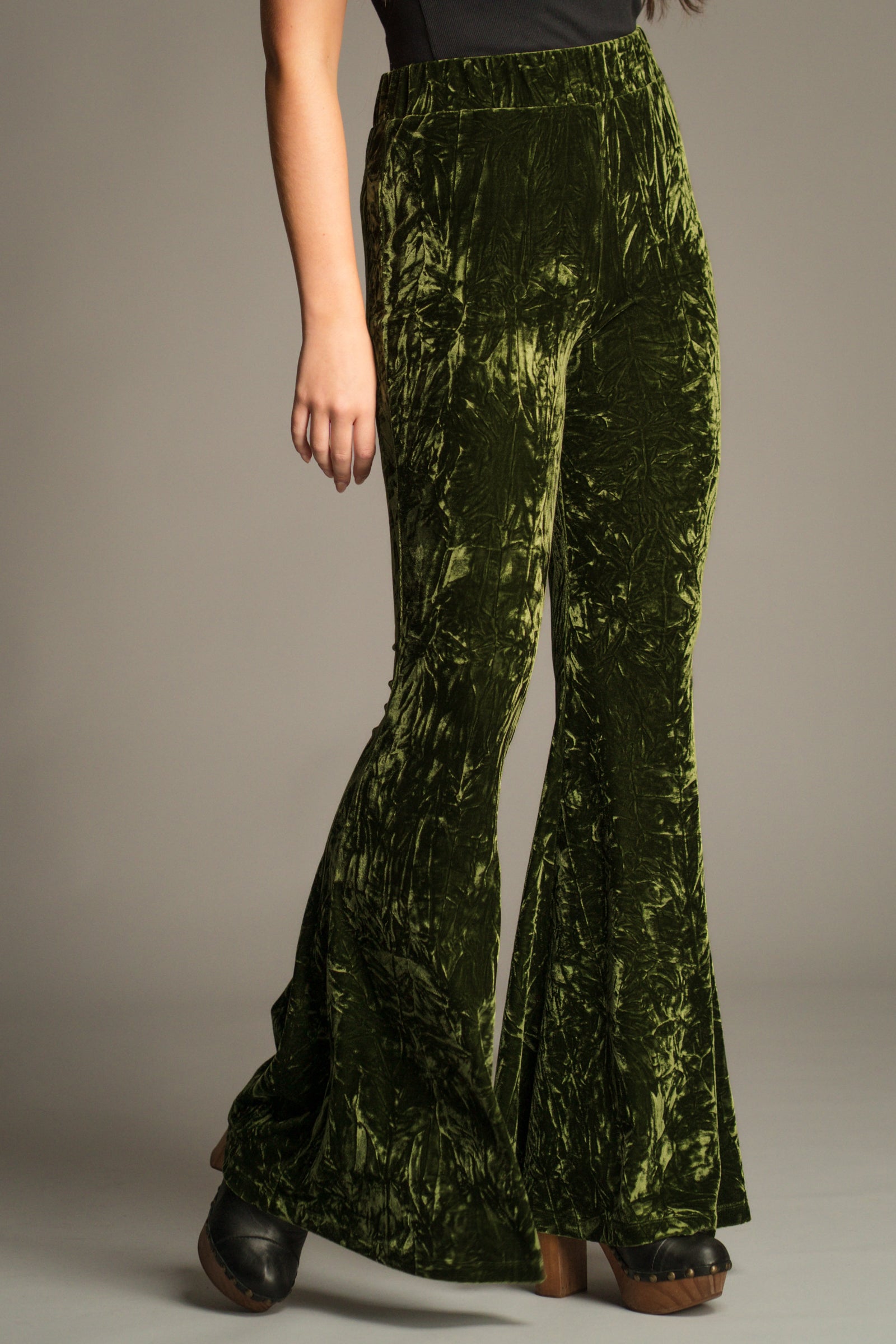 Close-up front view of the Hendrix Olive Crushed Velvet Flares showing high-rise fit and velvet texture.