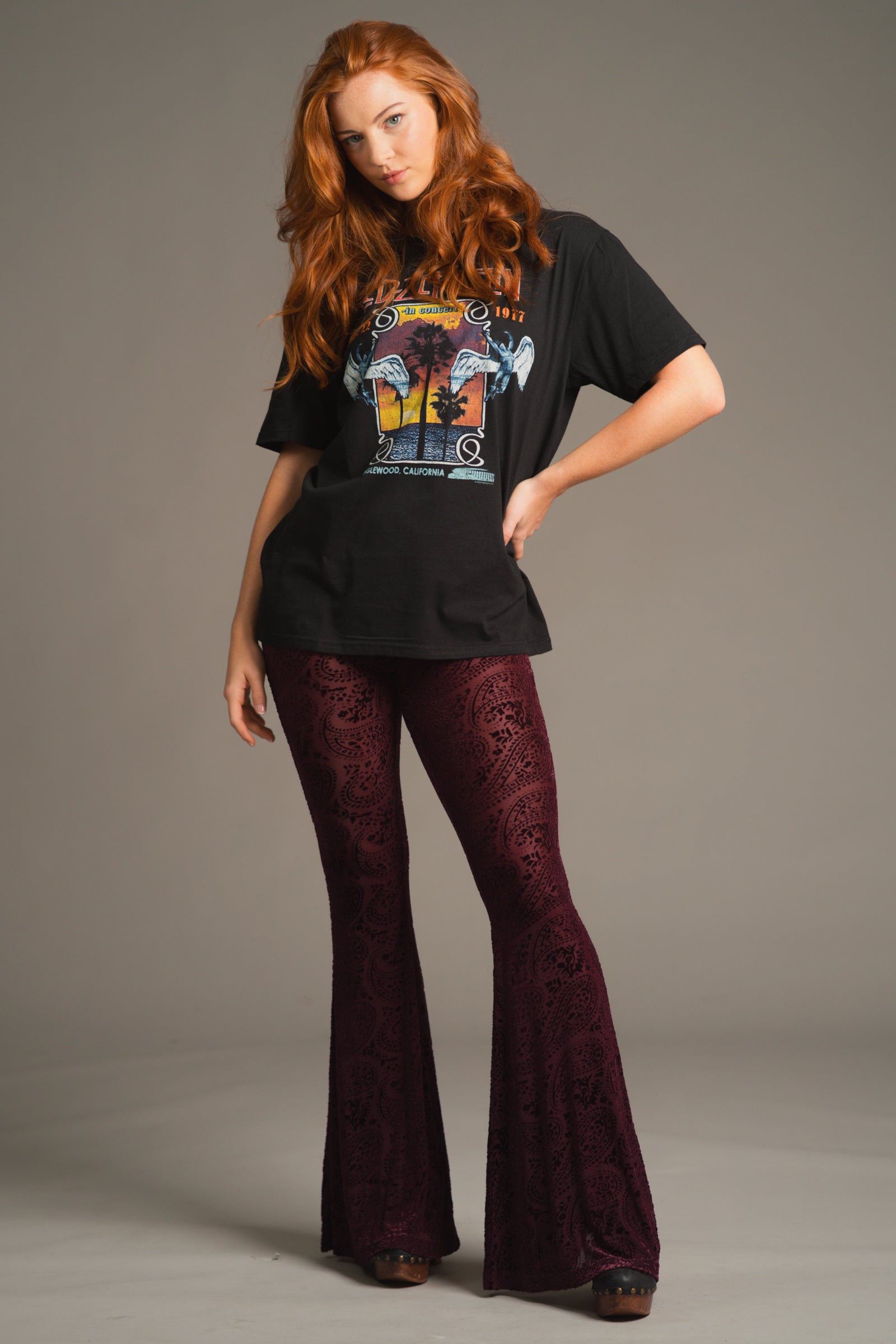 Anna wearing 70s inspired outfit featuring Hendrix Plum devore flares and Led Zeppelin Band Tee. 