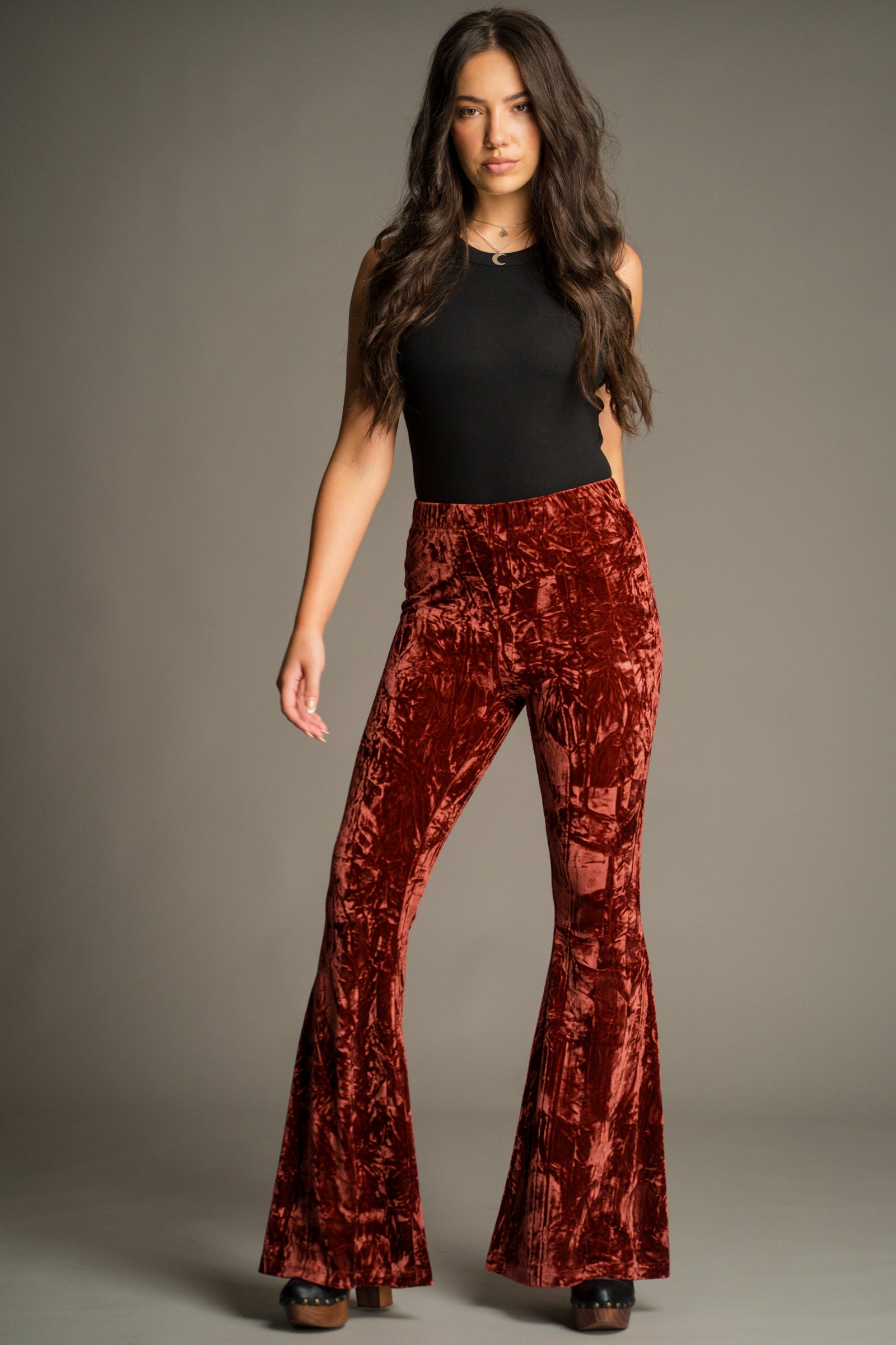 Hendrix Rust Crushed Velvet Flares by Little Lies featuring a flattering high-waisted silhouette and statement seventies-inspired flare