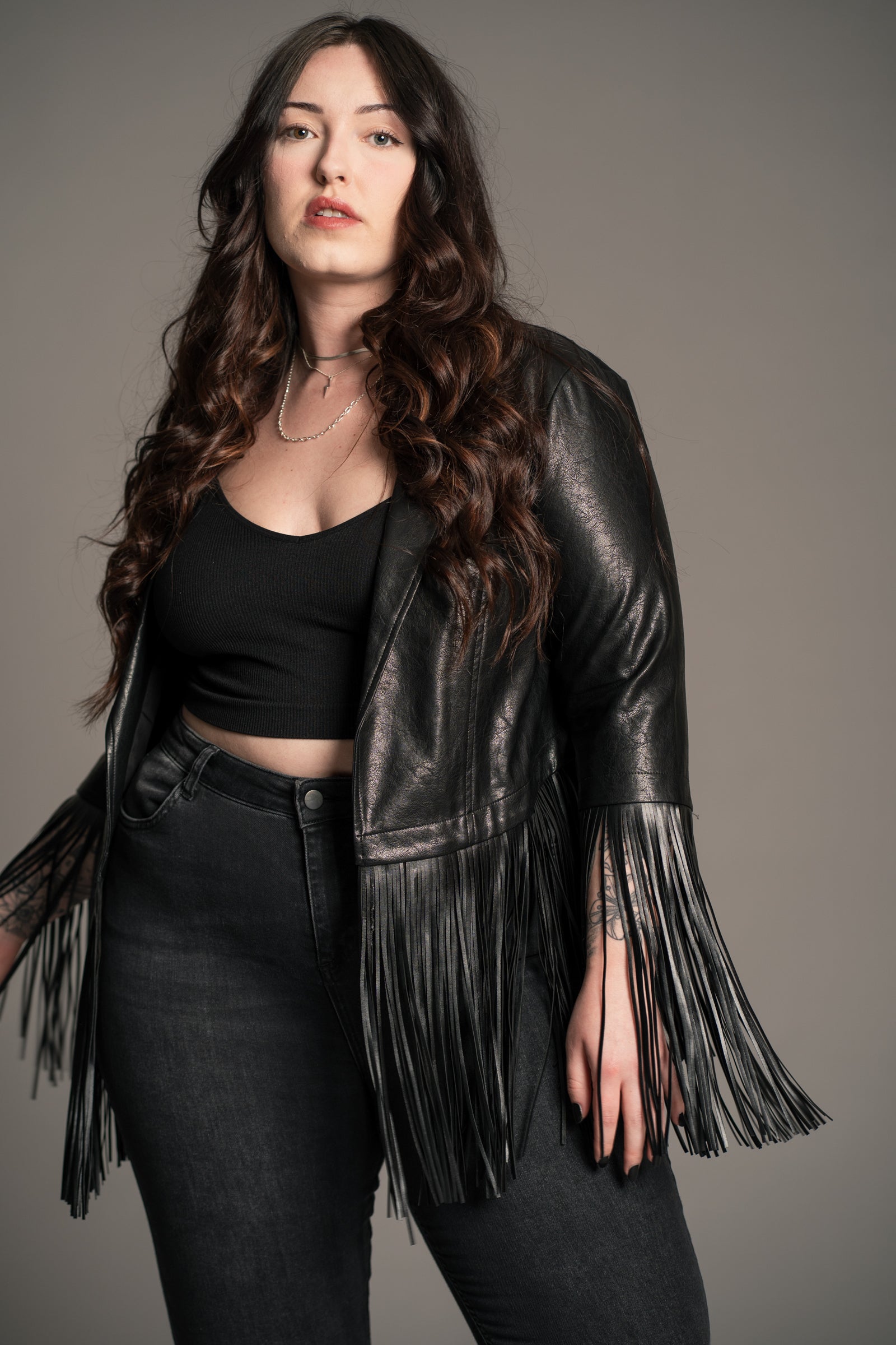 Side view of Little Lies Jagger Fringed Faux Leather Jacket showing fringe movement and blazer cut
