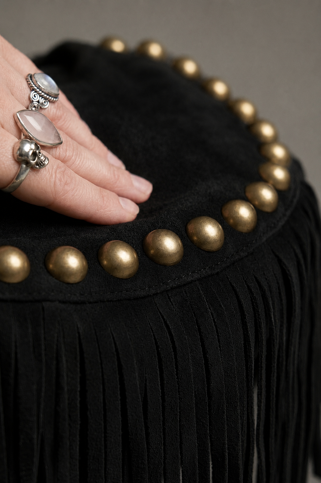 Little Lies Kate black genuine suede studded fringe bag with gold stud detailing and tassel trim, close‑up texture view