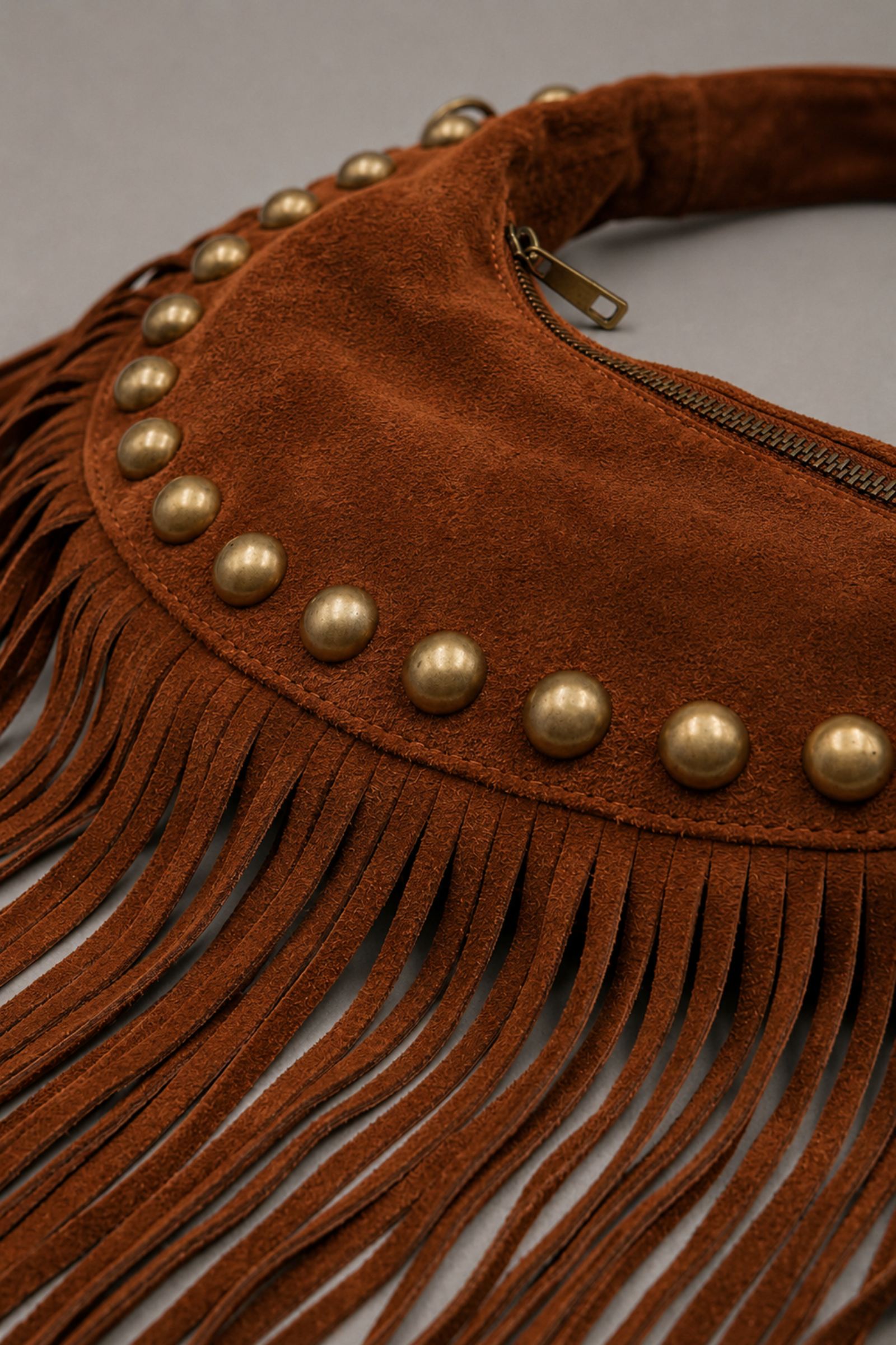 Little Lies Kate tan suede studded bag detail with fringe trim, gold stud accents  and zip closure close-up
