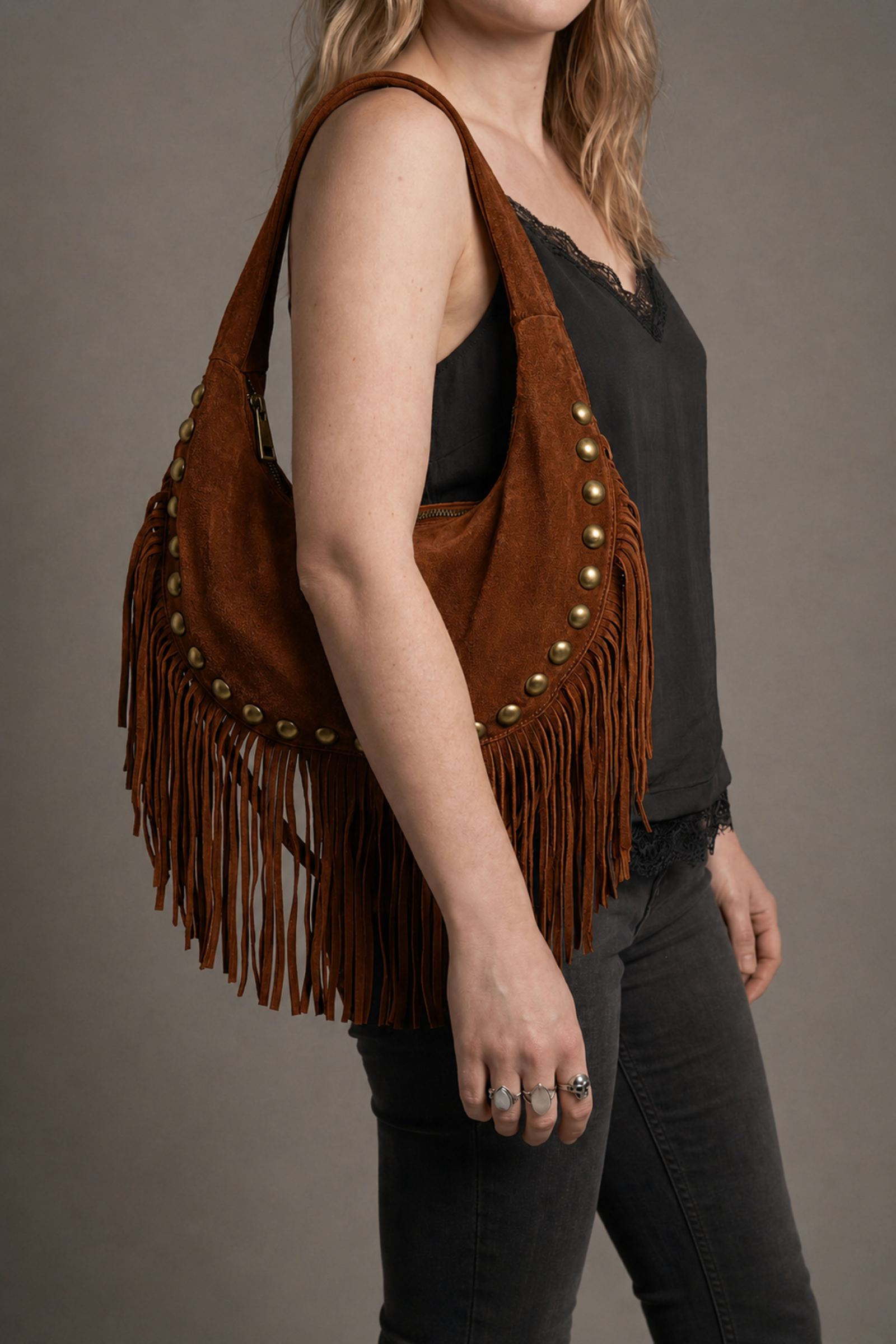 Little Lies Kate tan suede studded fringe bag – relaxed shoulder bag front view on model