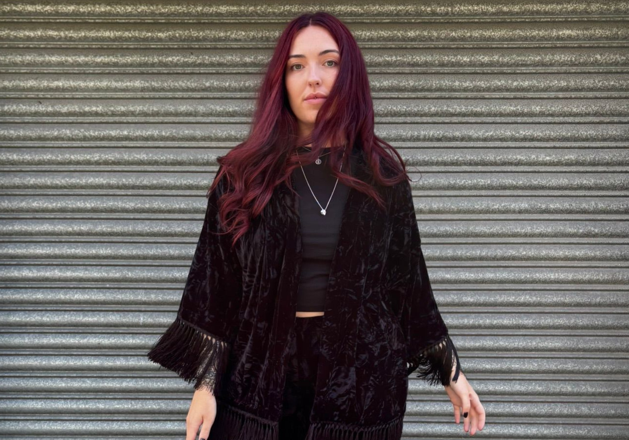 Rock City Crushed Velvet Black Kimono in front of Roller Door. 