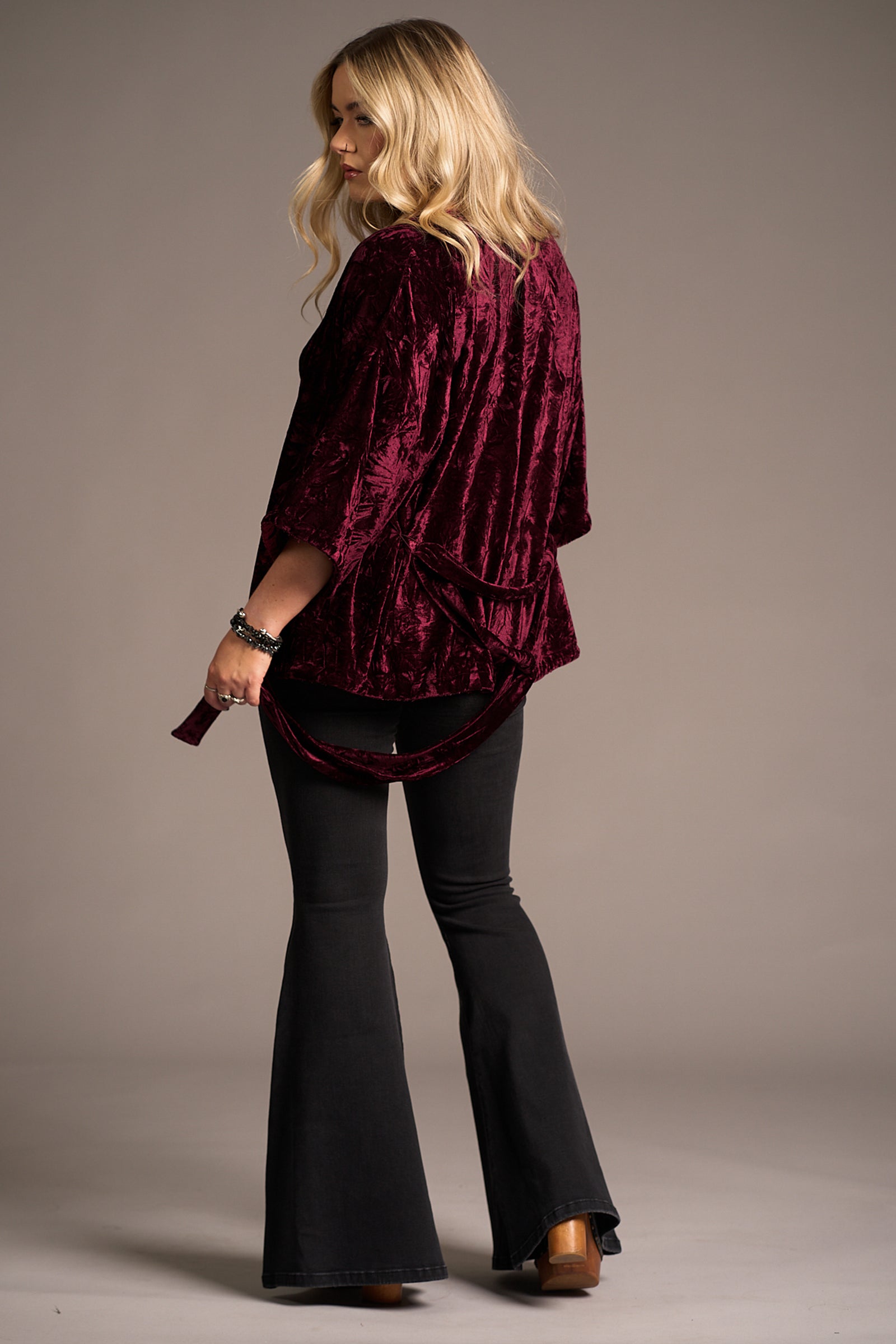 Erin showing the back of the Lana Merlot Velvet Kimono, tie detail. Stevie Nicks inspired styling studio